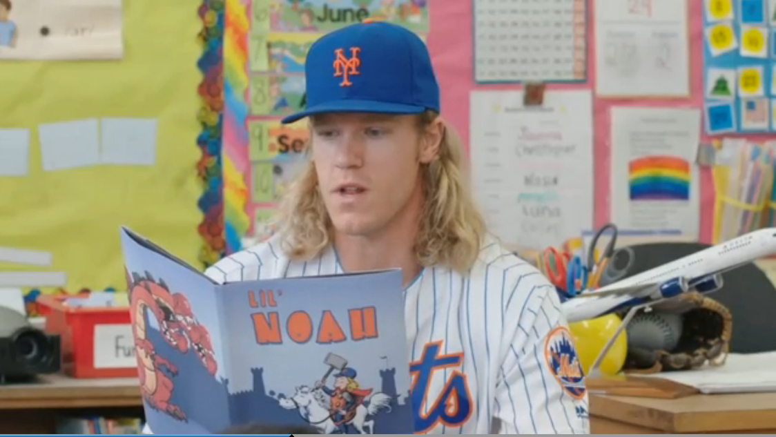 Noah reading to Kindergartners with the book cover I designed
