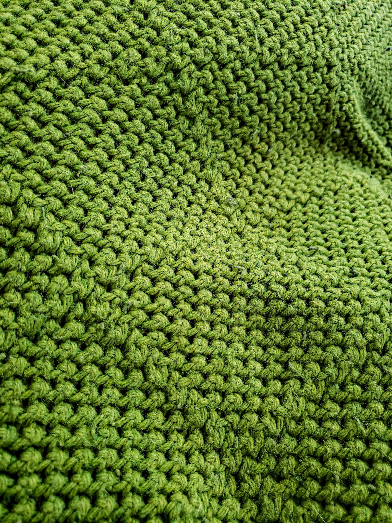 Orem, UT, US - Jun 27, 2020: Closeup of green knit throw blanket