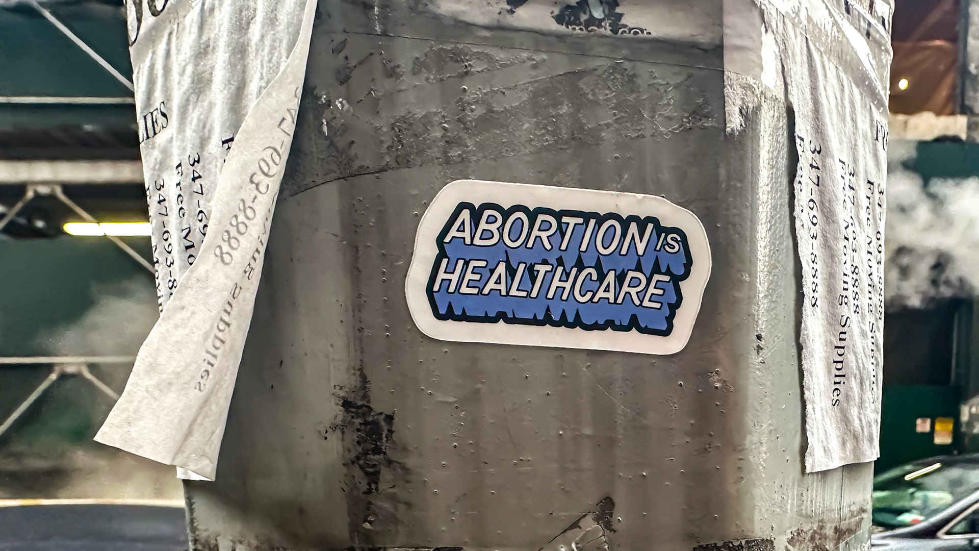 New York, NY, US - Sep 10, 2023: Wet flyers and sticker reading "abortion is healthcare" on Manhattan lamppost