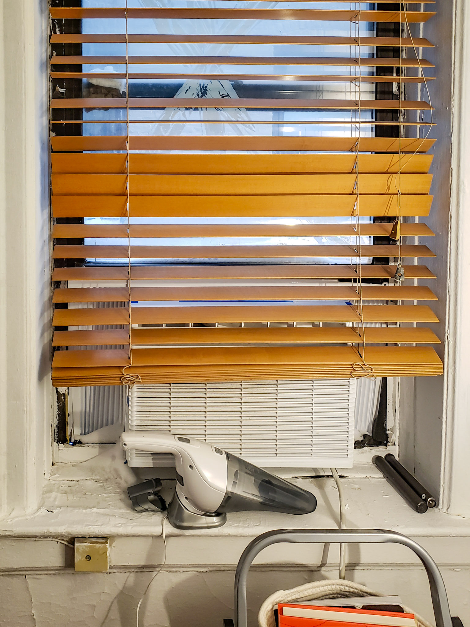 New York, NY - Jan 29, 2022: Washington Heights apartment window with snow leaking through air conditioner