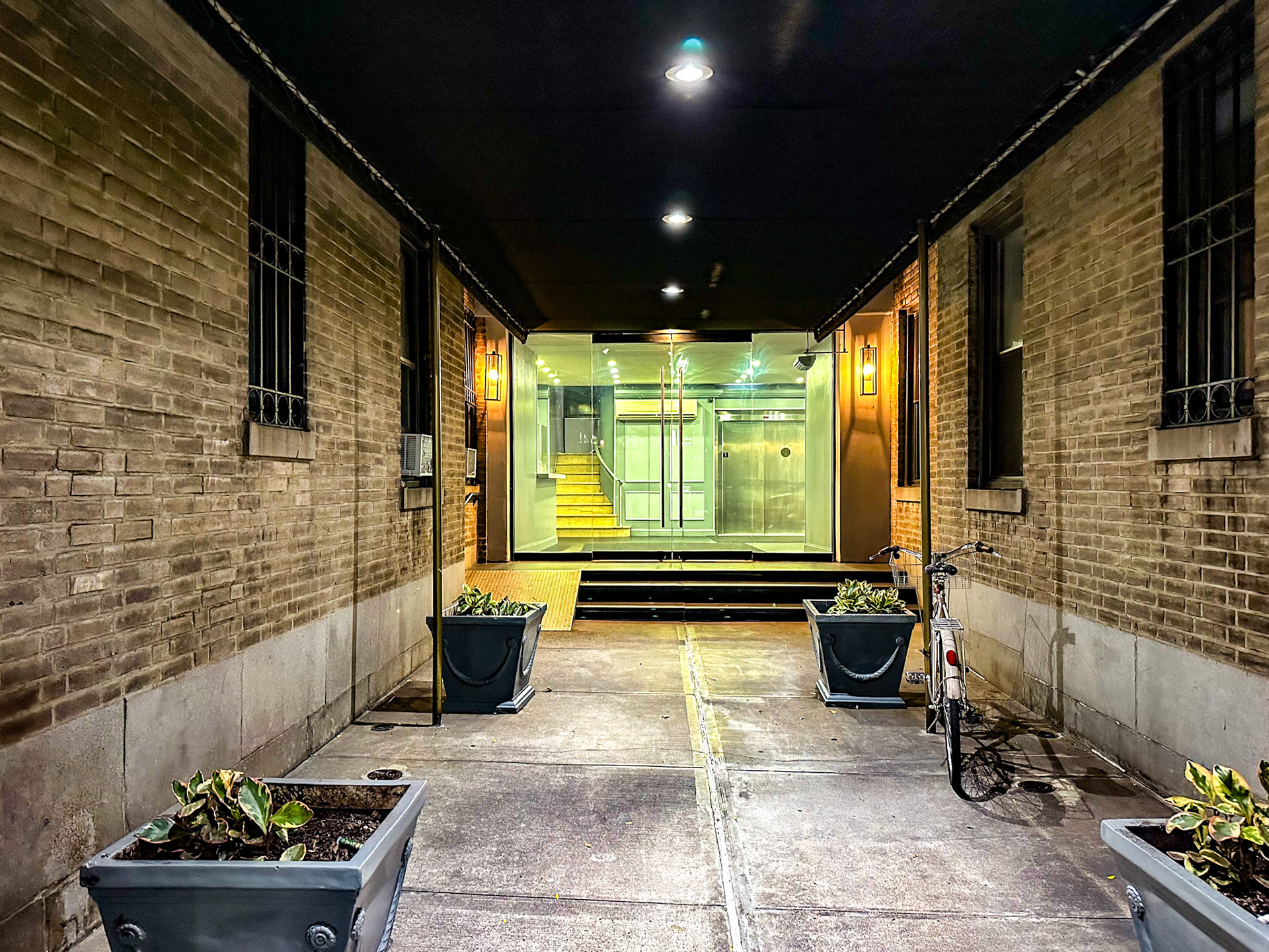 New York, NY, US - Oct 8, 2023: Building entrance with glass doors at night