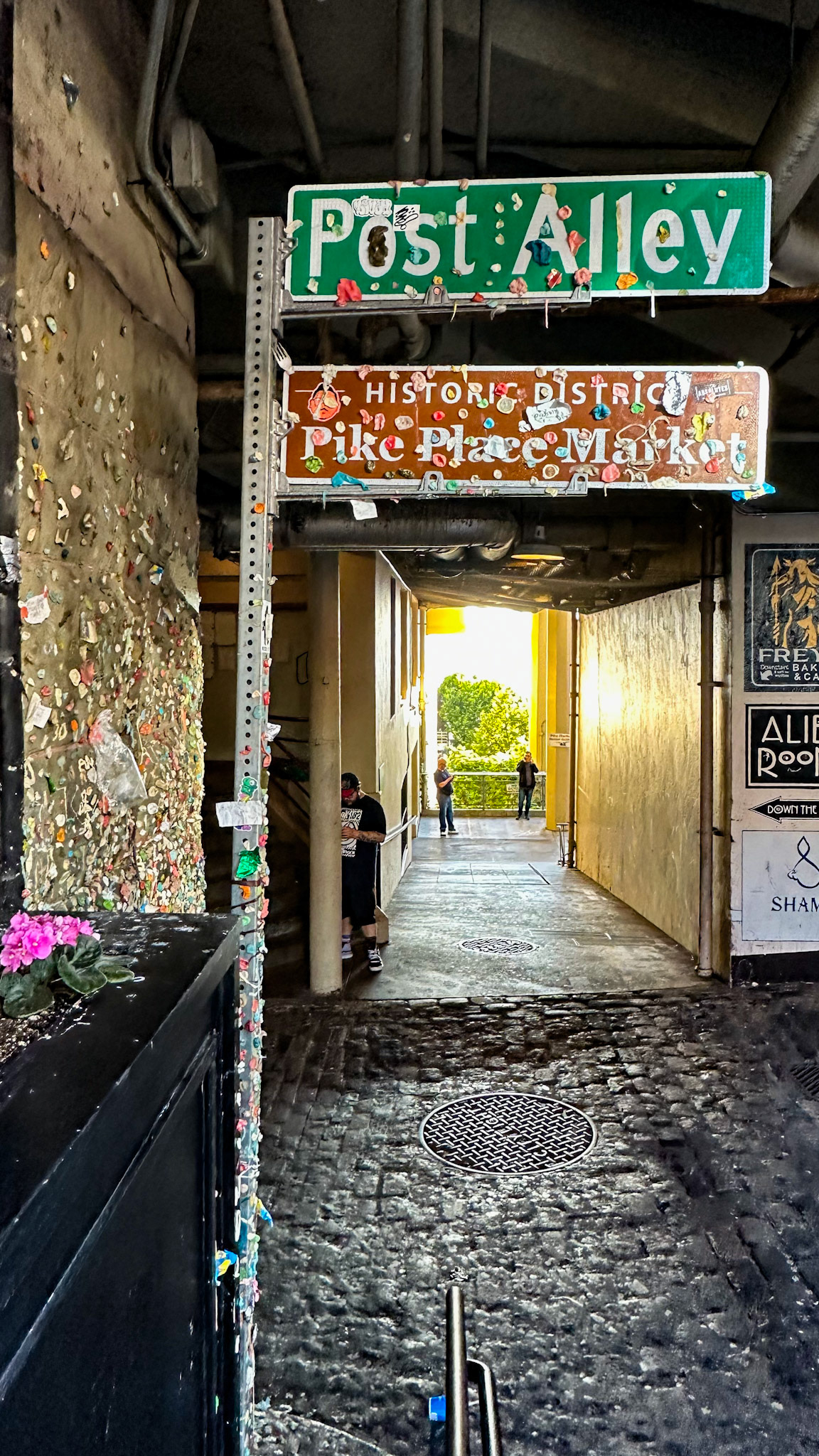 Seattle, WA, US - Aug 9, 2023: Chewing gum-covered street signs in Post Alley, Pike Place Market