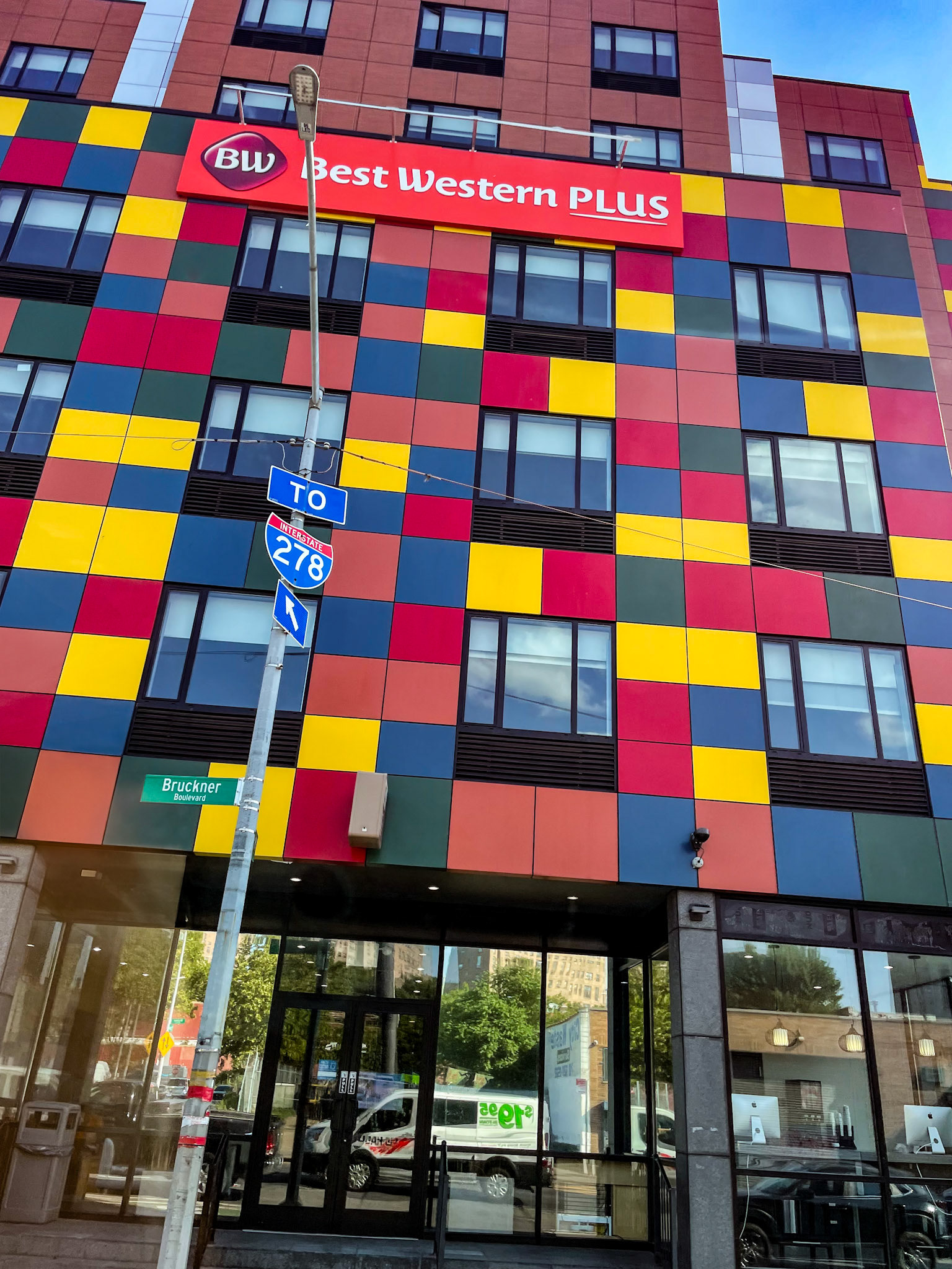 Colorful Best Western with moving truck reflected in windows