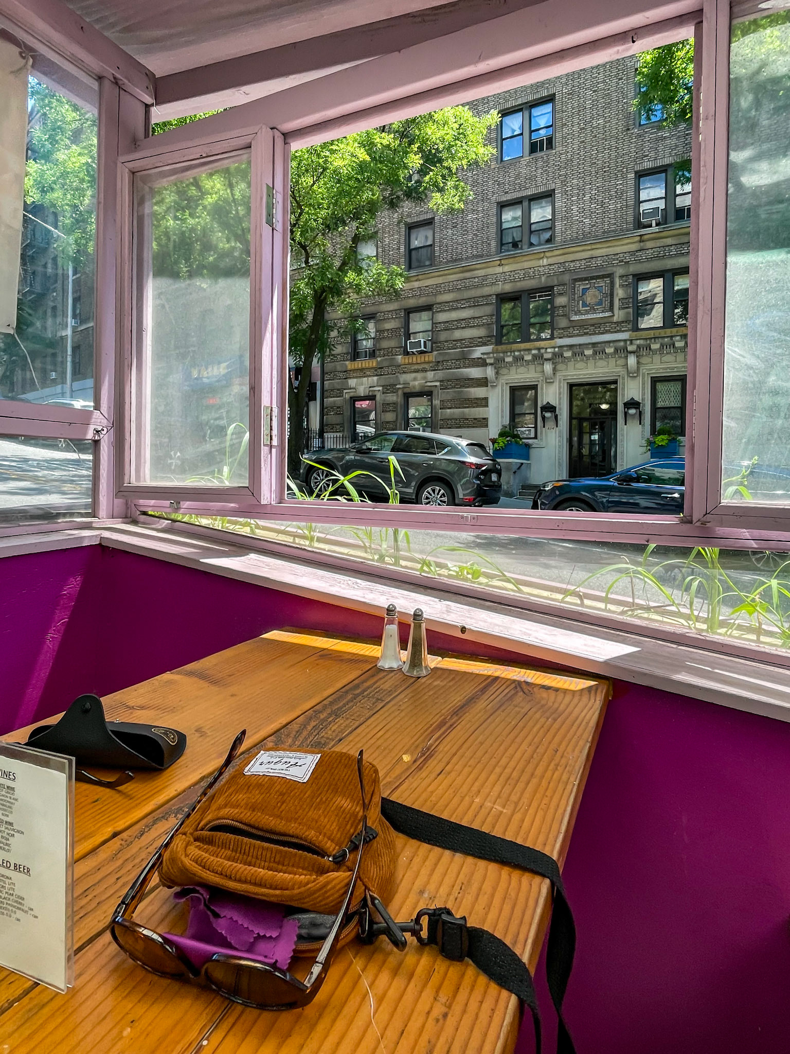 New York, NY, US - Jun 20, 2022: Small corduroy bag on table inside Chelsea outdoor dining structure