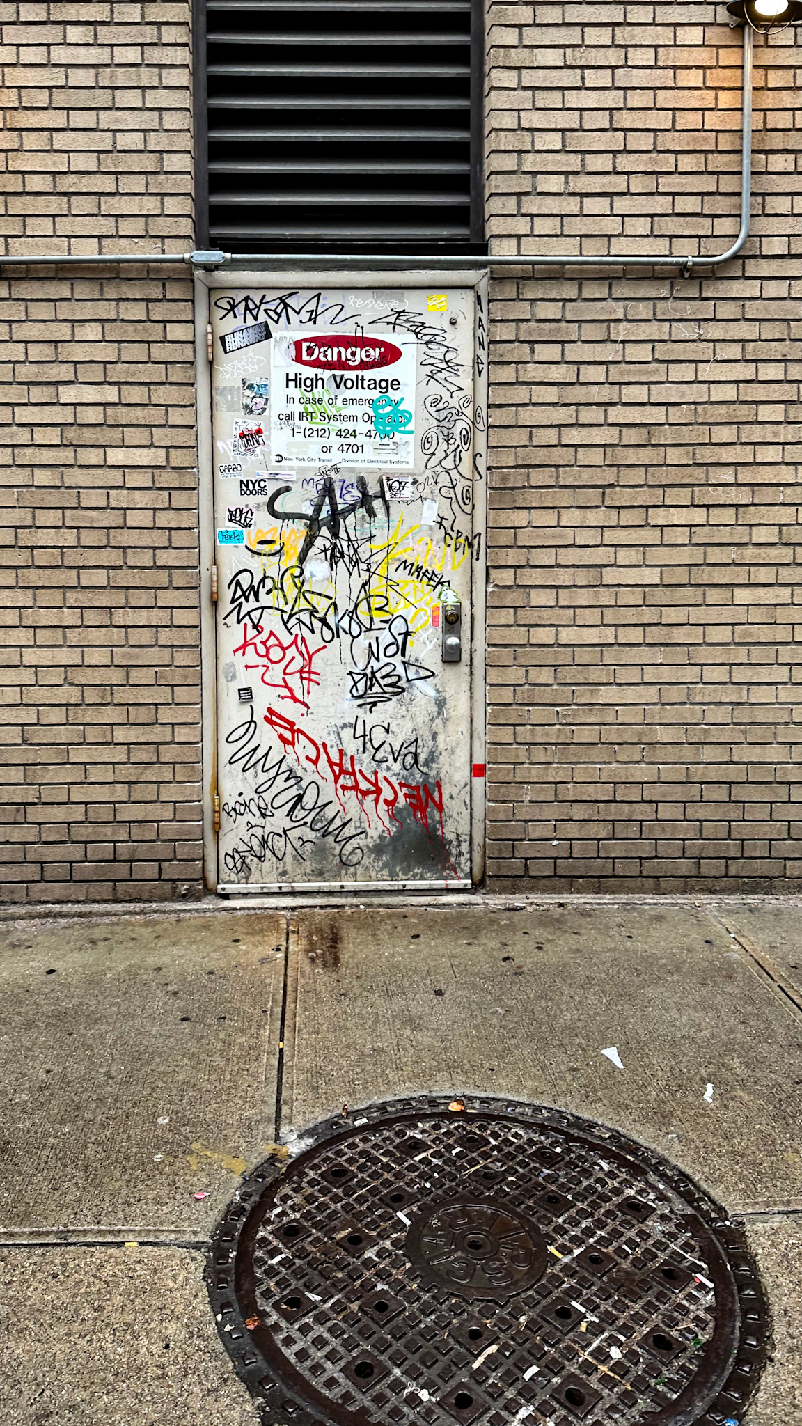 New York, NY, US - Apr 5, 2023: Door in brick wall covered in graffiti