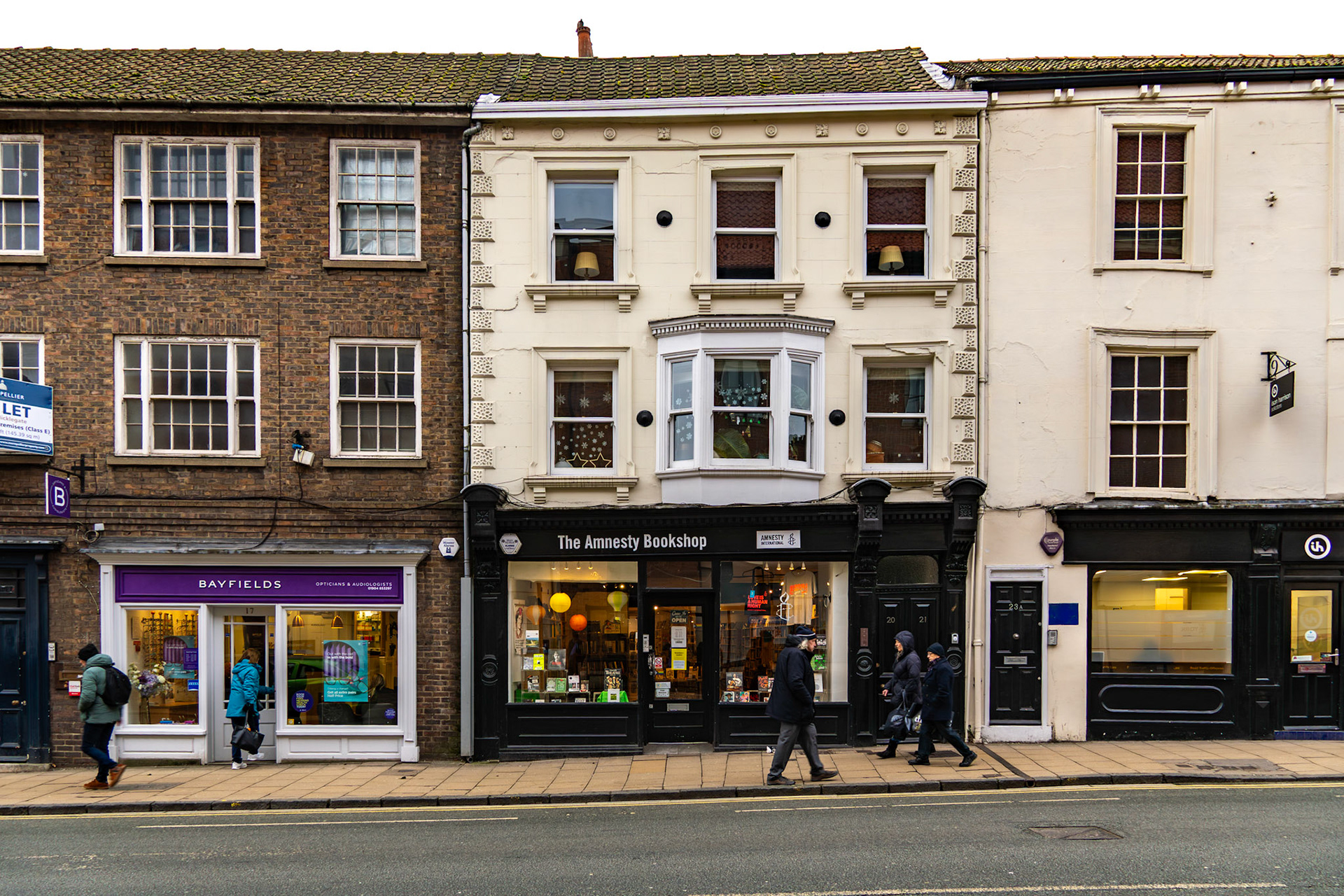 York, North Yorkshire, UK - Jan 12, 2024: Amnesty Bookshop and other Micklegate storefronts