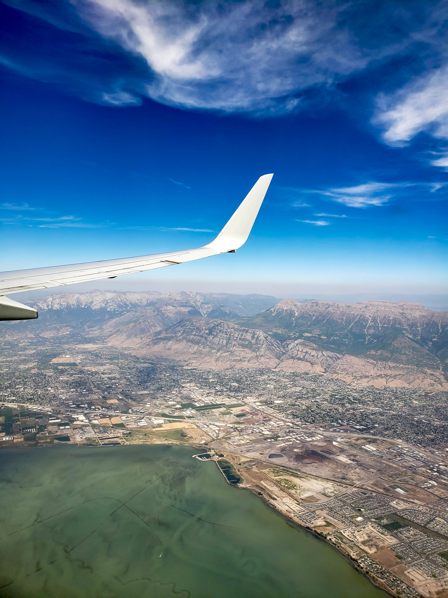 Provo, UT, US - Aug 14, 2020: Flying over Utah Lake, Orem, Provo, and the Wasatch Mountains