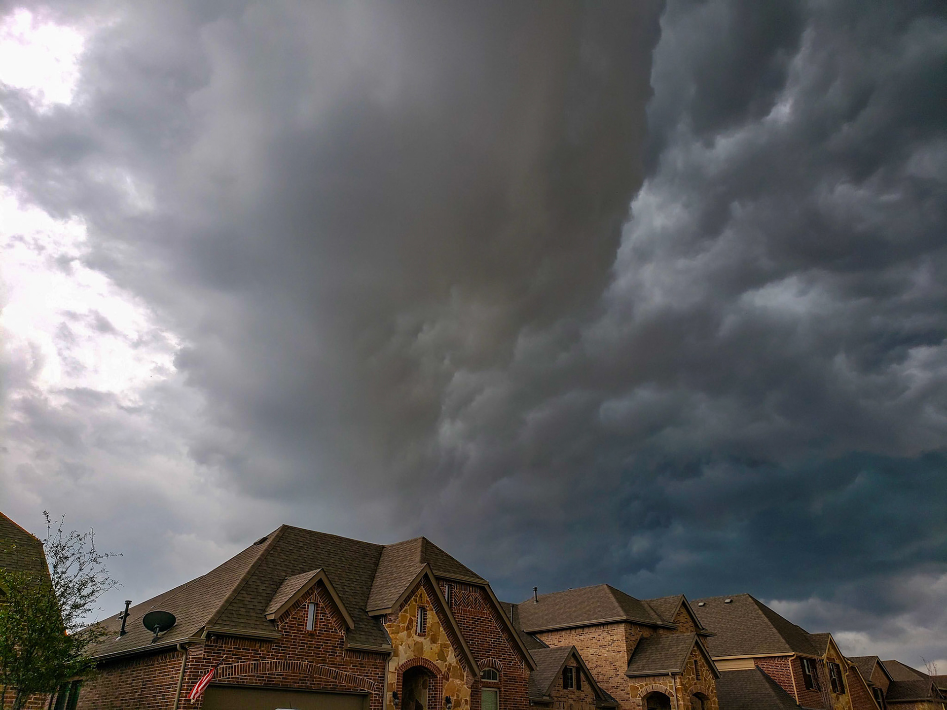 McKinney, TX, US - Mar 19, 2020: Heavy rain clouds over neighborhood homes