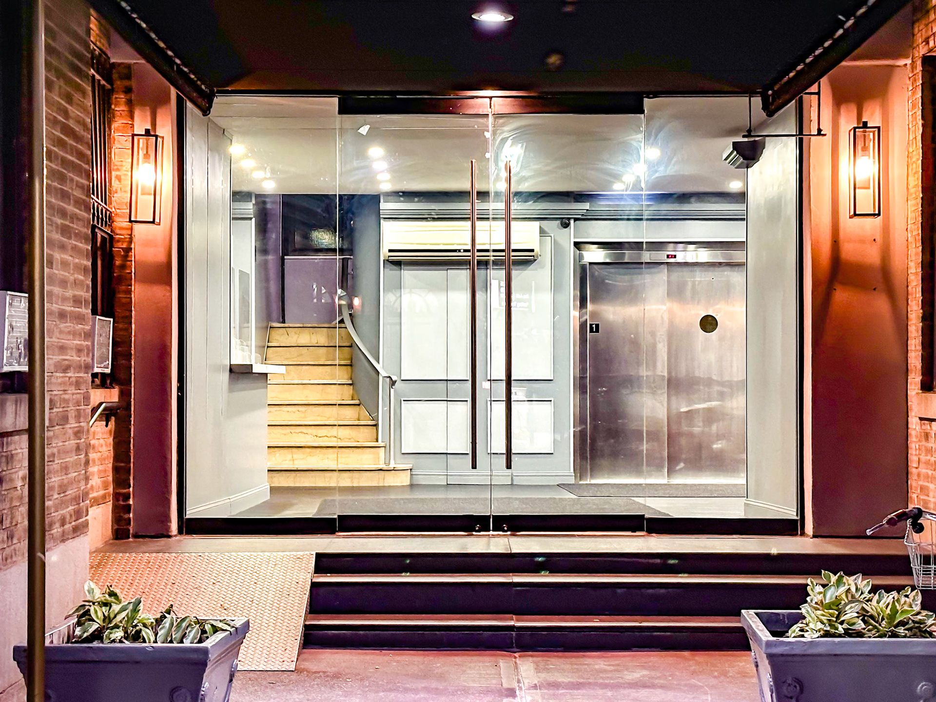 New York, NY, US - Oct 8, 2023: Building entrance with glass doors at night