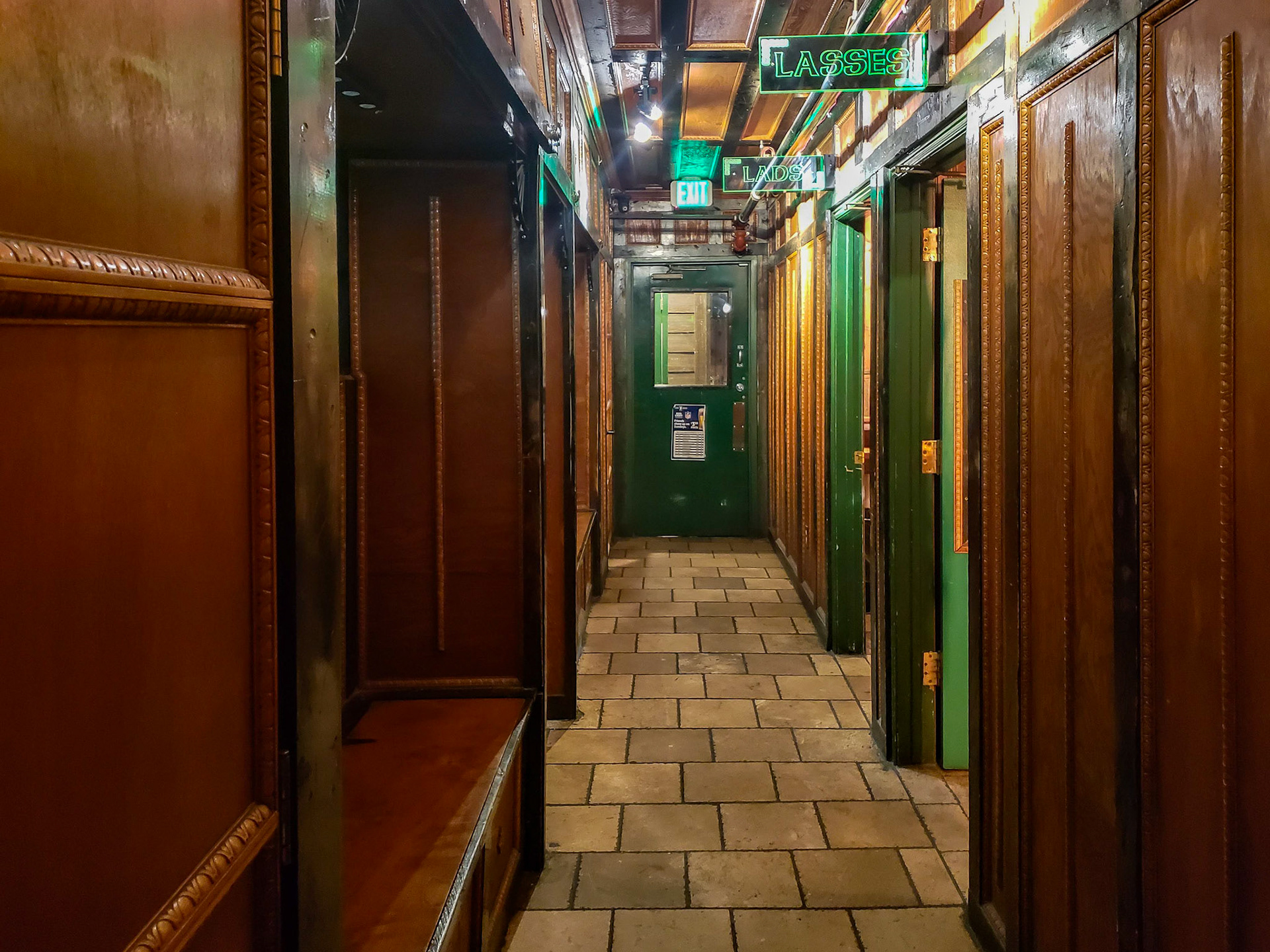 Salt Lake City, UT, US - Nov 11, 2018: Exit hallway with doors to bathrooms labeled "lasses" and "lads"