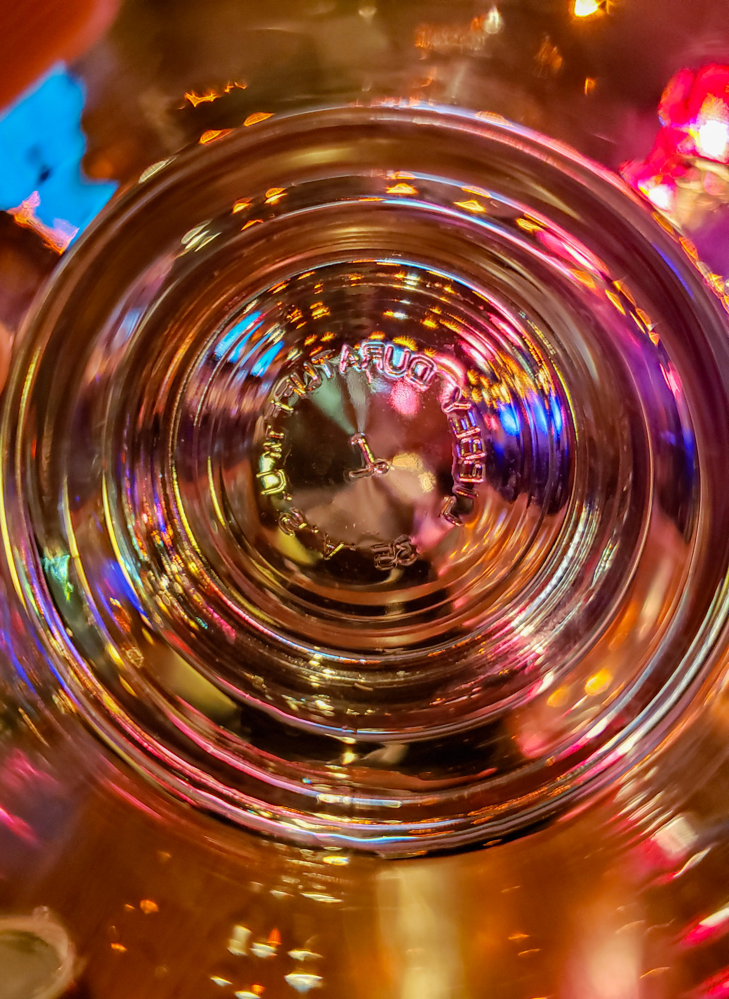 Plano, TX, US - Jan 27, 2021: Colorful lights seen through the bottom of a glass