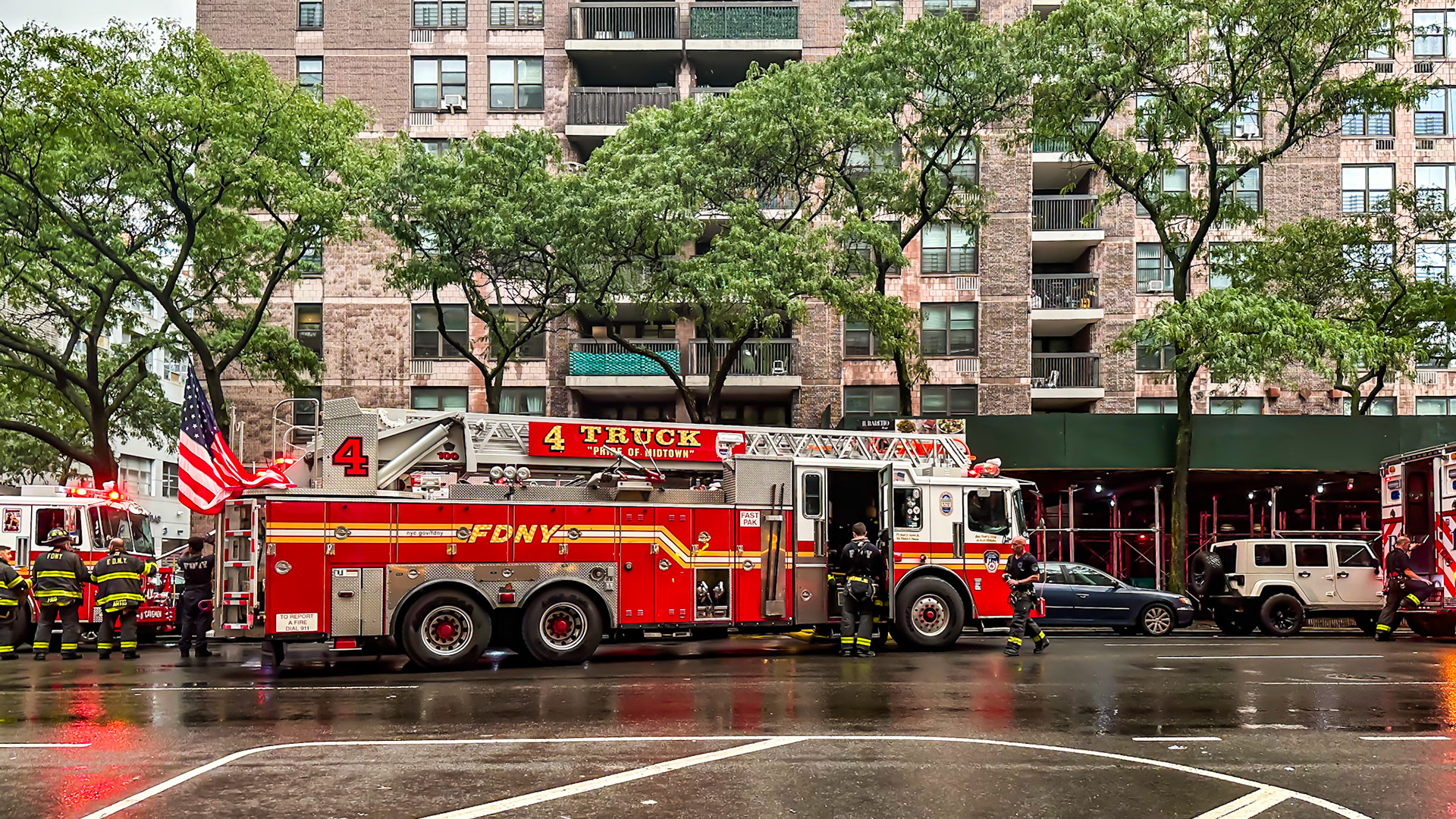 New York, NY, US - Sep 11, 2023: Fire trucks and firefighters on rainy 11th Ave