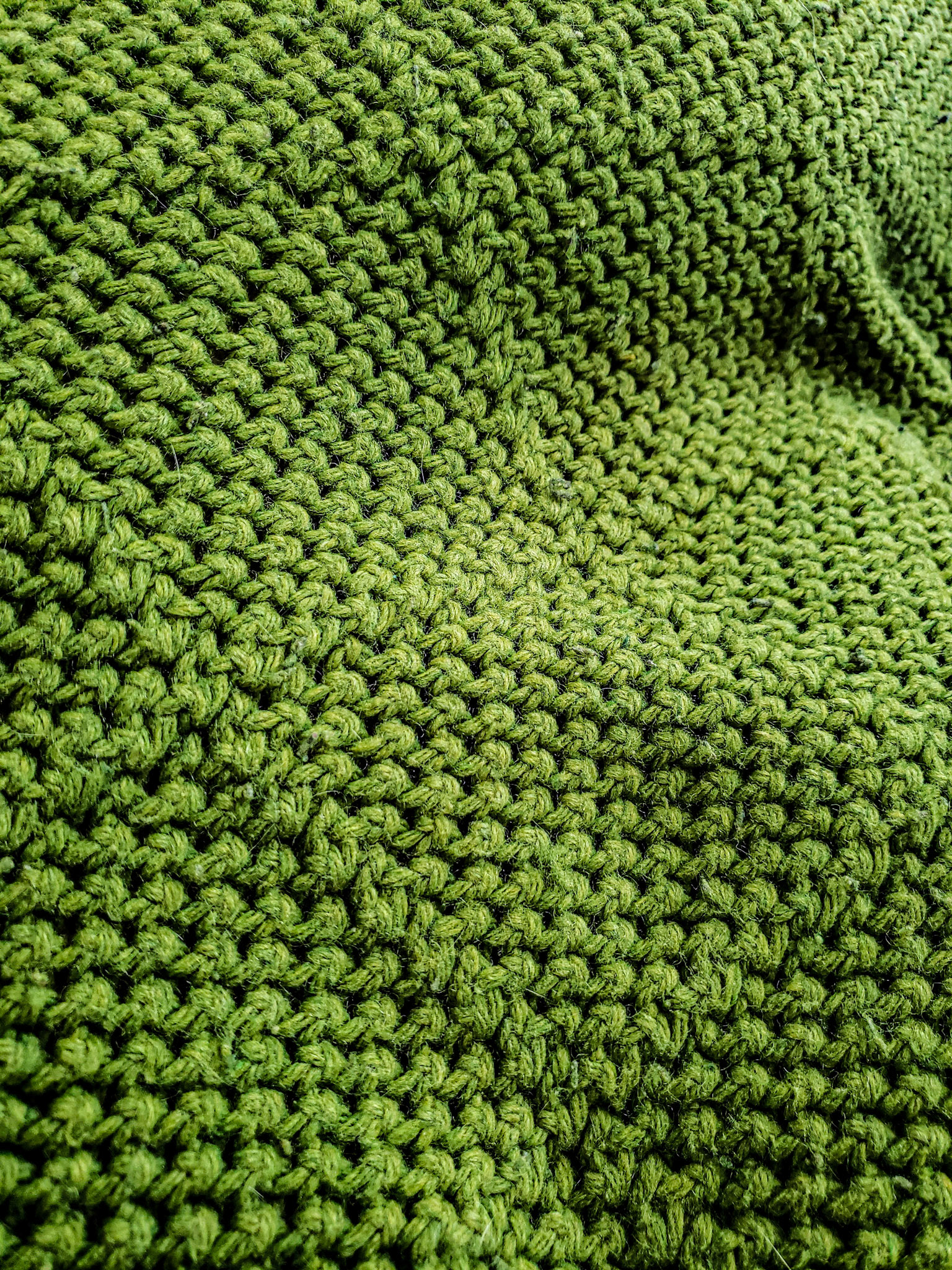 Orem, UT, US - Jun 27, 2020: Closeup of green knit throw blanket