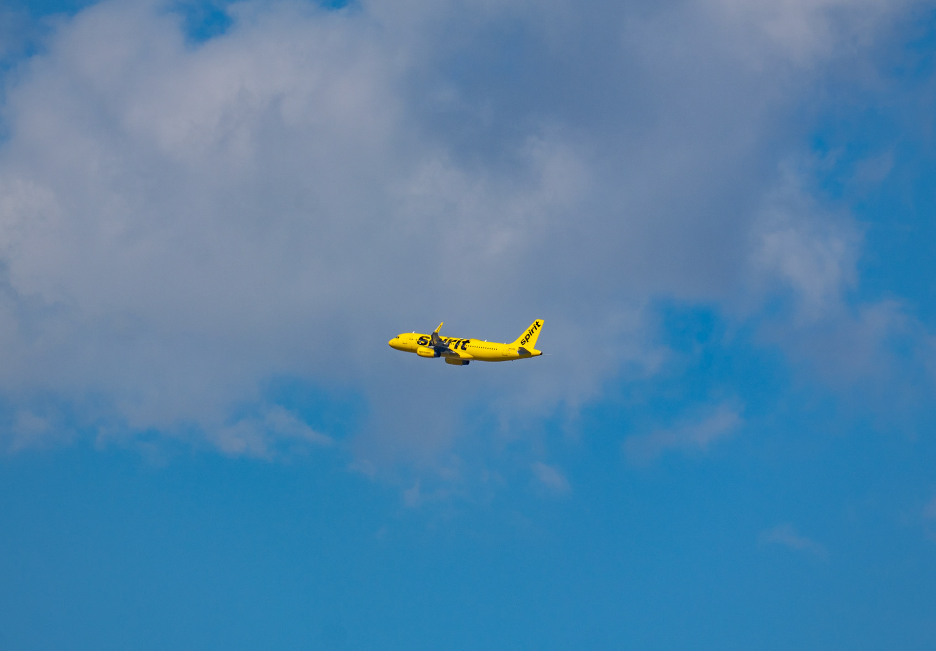 Grapevine, TX, US - May 9, 2025: Spirit airlines against a blue sky with clouds