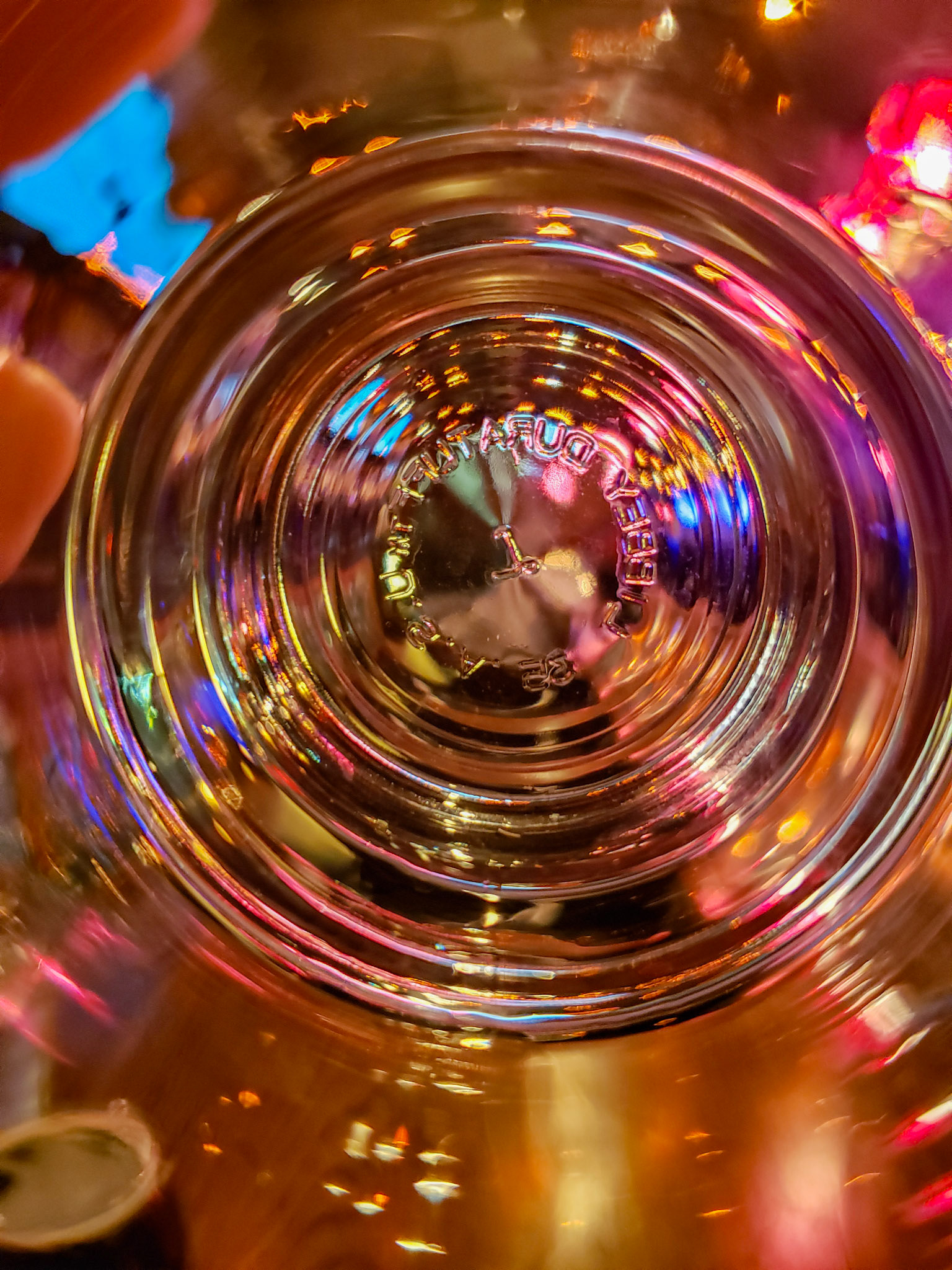 Plano, TX, US - Jan 27, 2021: Colorful lights seen through the bottom of a glass