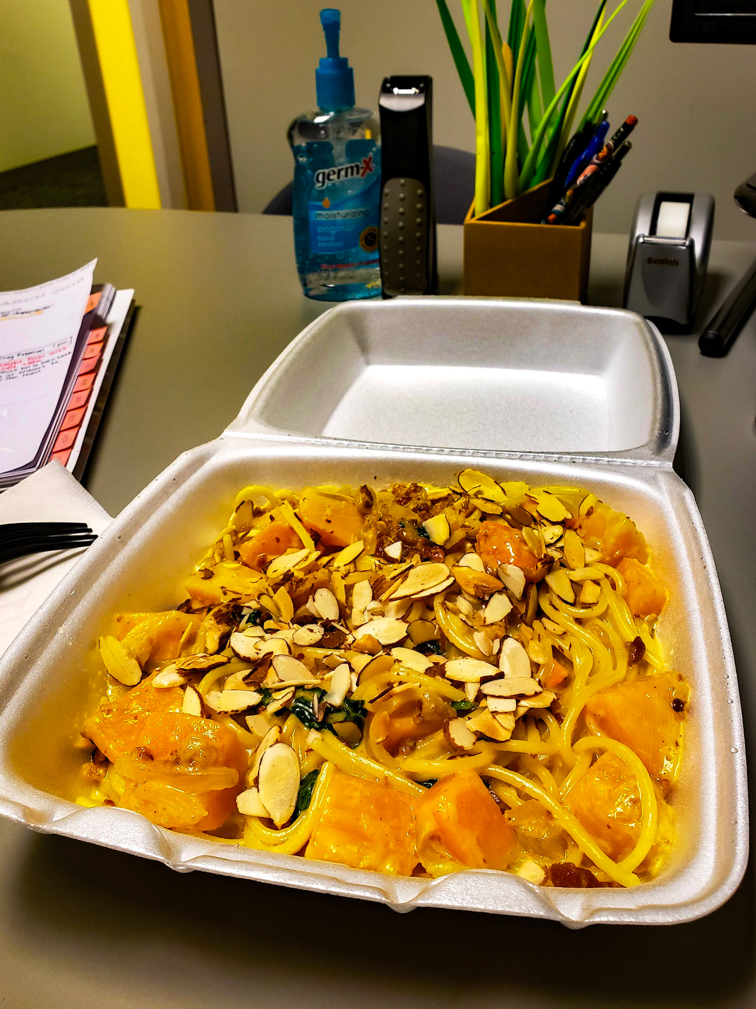Provo, UT, US - Mar 29, 2019: Pasta in open takeout container on work desk