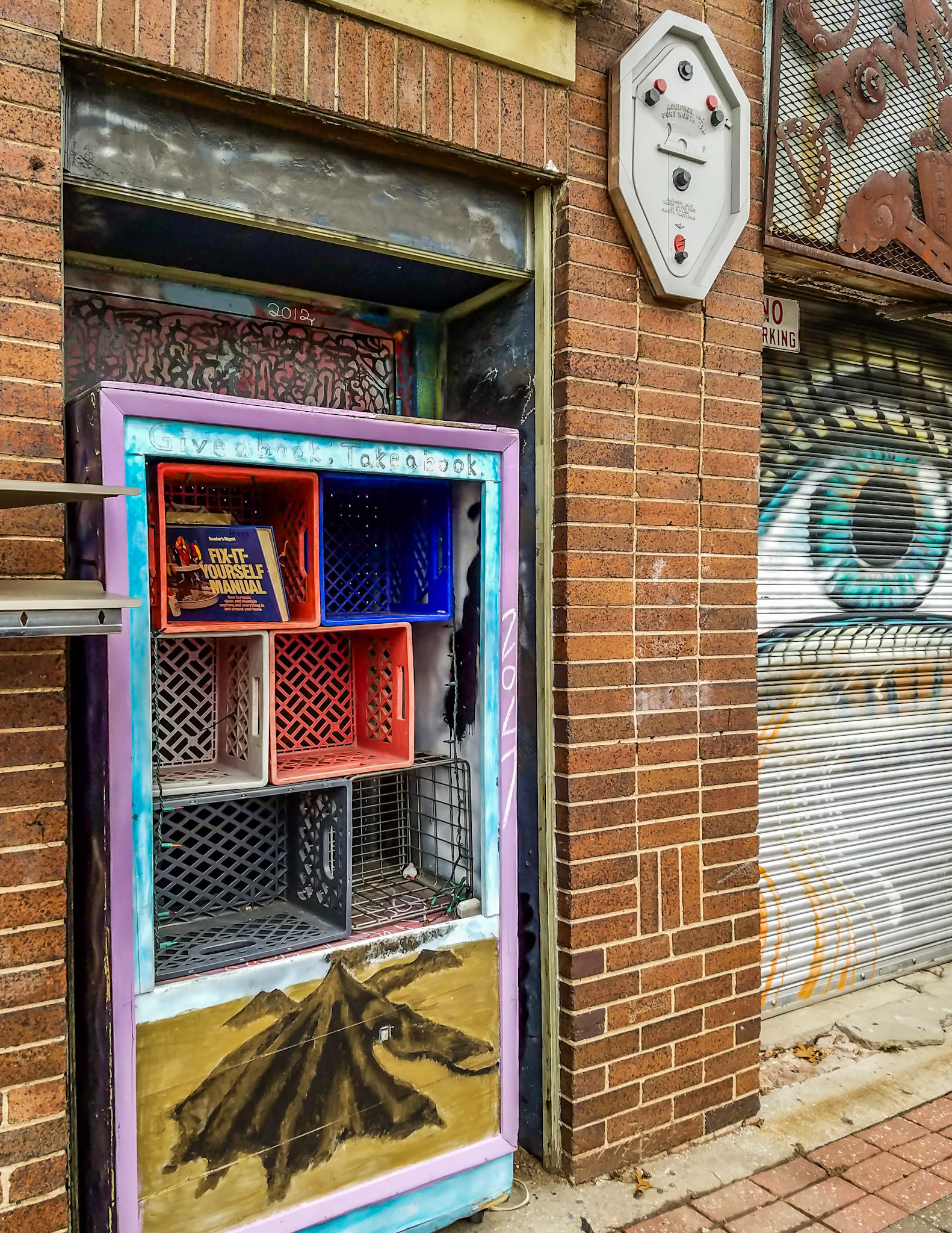 Dallas, TX, US - Dec 4, 2016: Street art and a free sharing library in Deep Ellum
