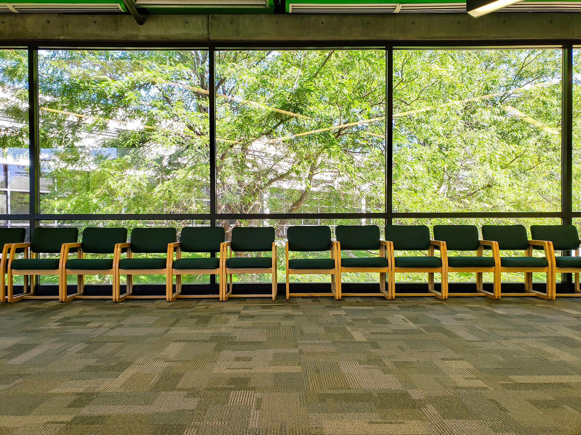 Orem, UT, US - Aug 20, 2019: Hallway seating with trees outside window