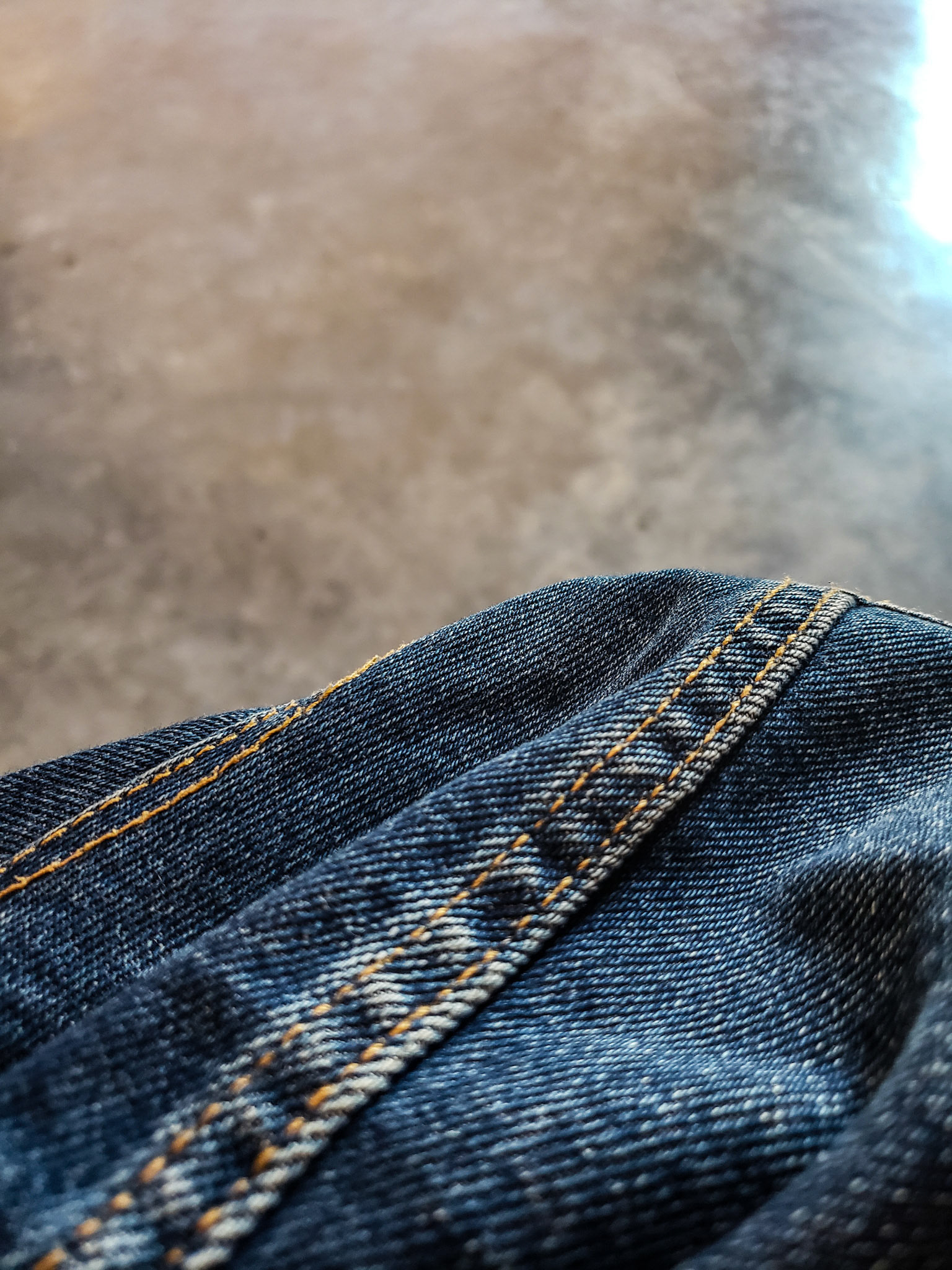 Sunnyvale, CA, US - Sep 28, 2021: Closeup of blue denim against cement floor