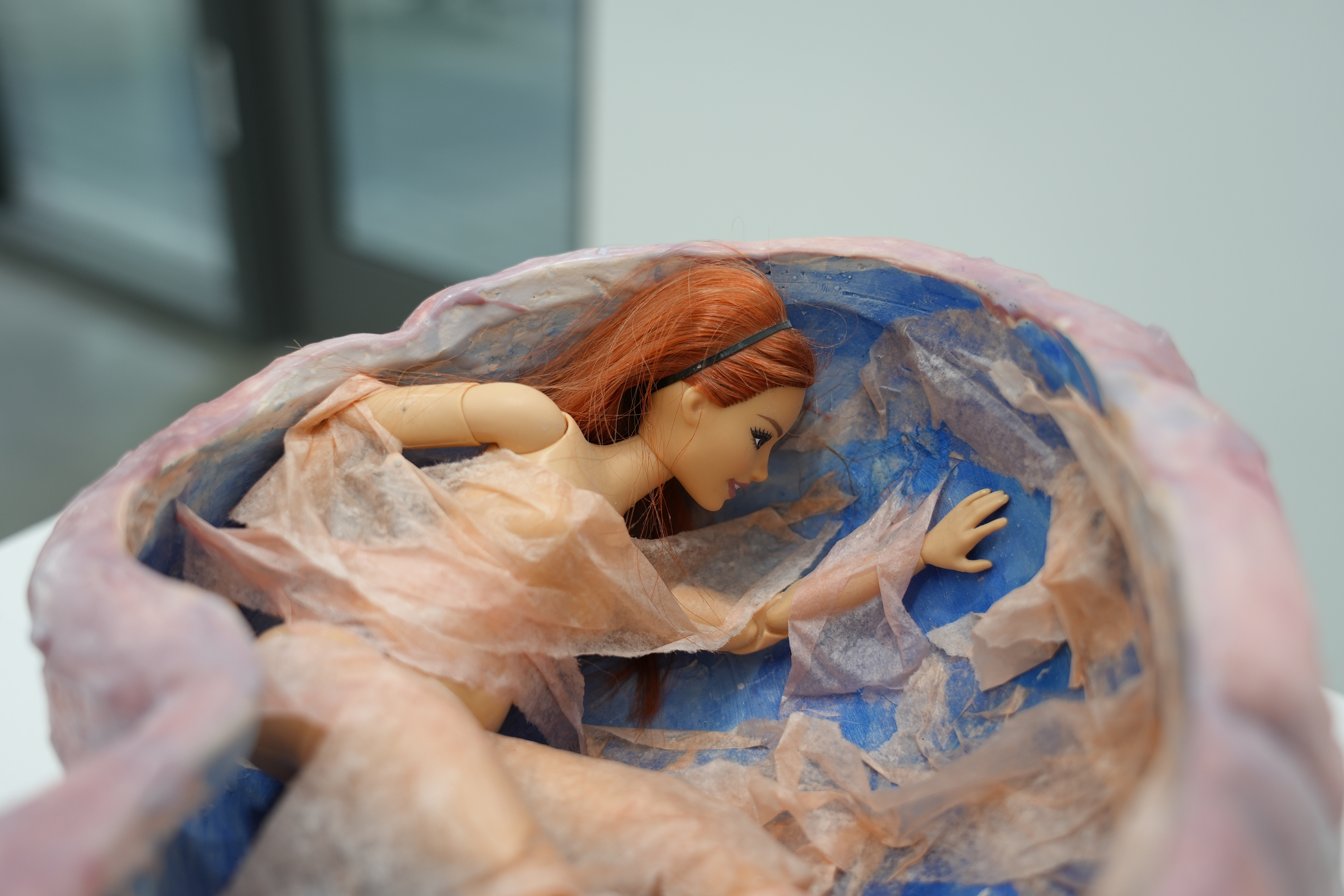 Mind-Space (ceramic sculpture with wax finish, paint, tissue paper, and Barbie doll)