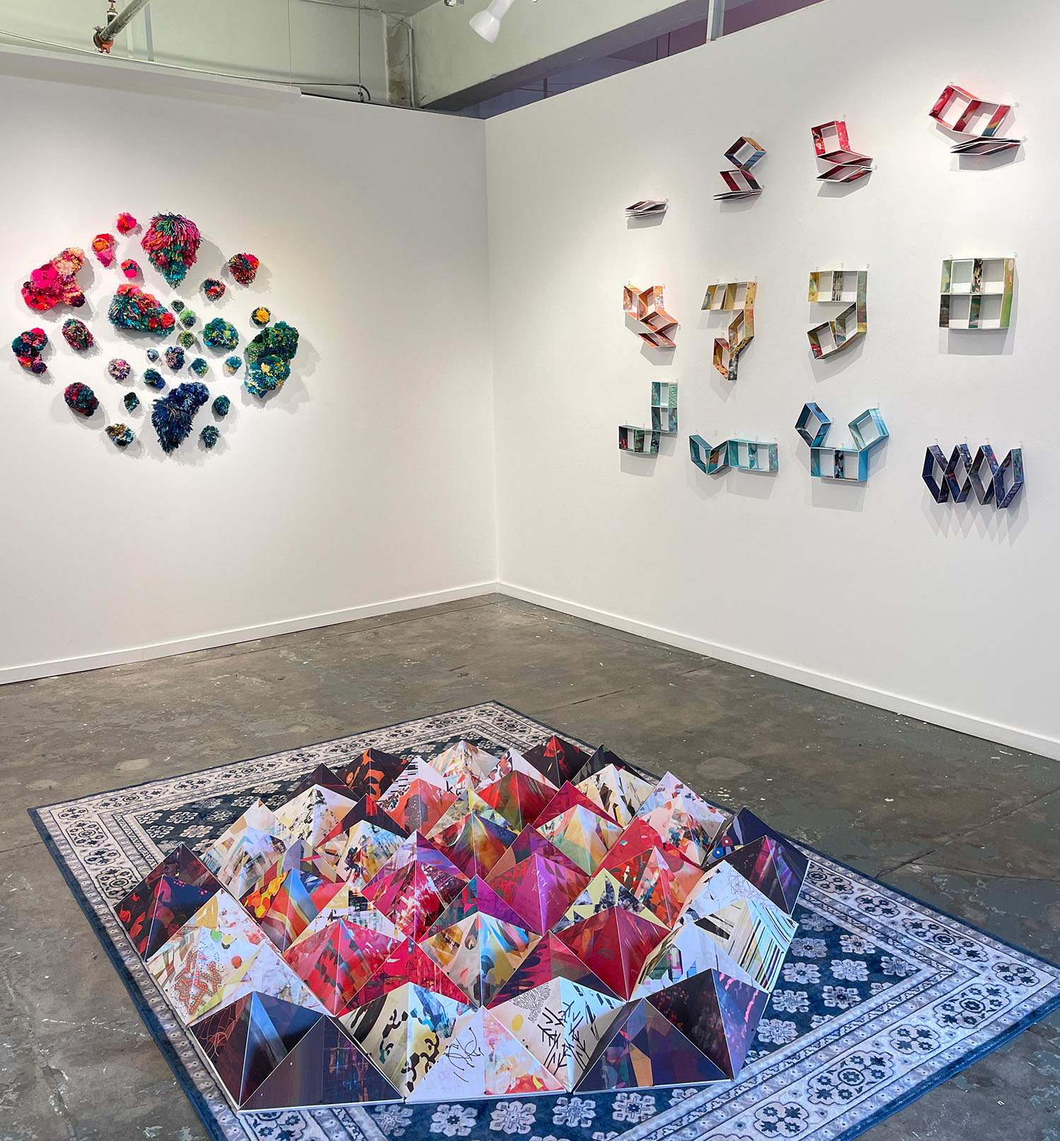 Installation view showing pompom works by Amanda Triplett, and 'Tween' (wall) and 'Are We There Yet?' (floor) by Stephanie Krimmel