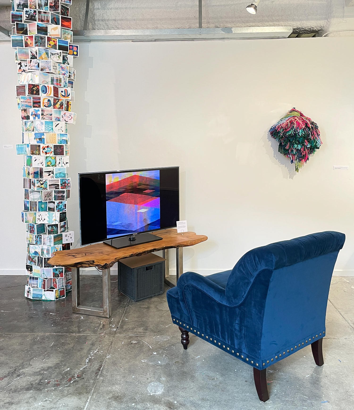 Installation view showing 'The Biggest Meeple' (on wall) by Amanda Triplett, and 'Make Yourself Comfortable' and 'Net Positive 1' by Stephanie Krimmel