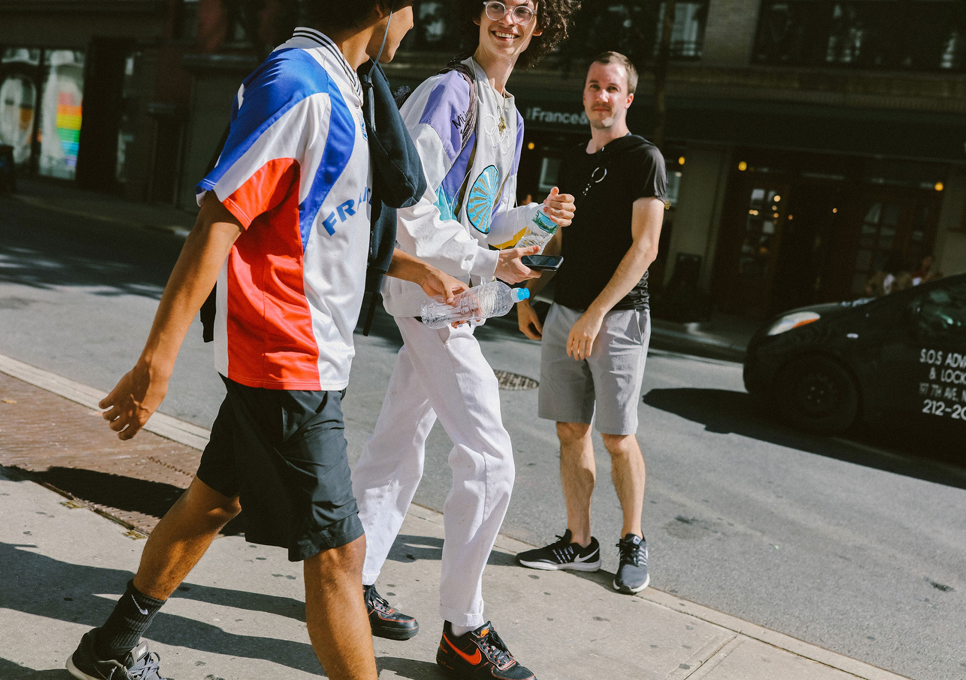 Young men wearing retro and reworked football jerseys styled as streetwear in New York City, reflecting 2025 fashion trends influenced by soccer culture.