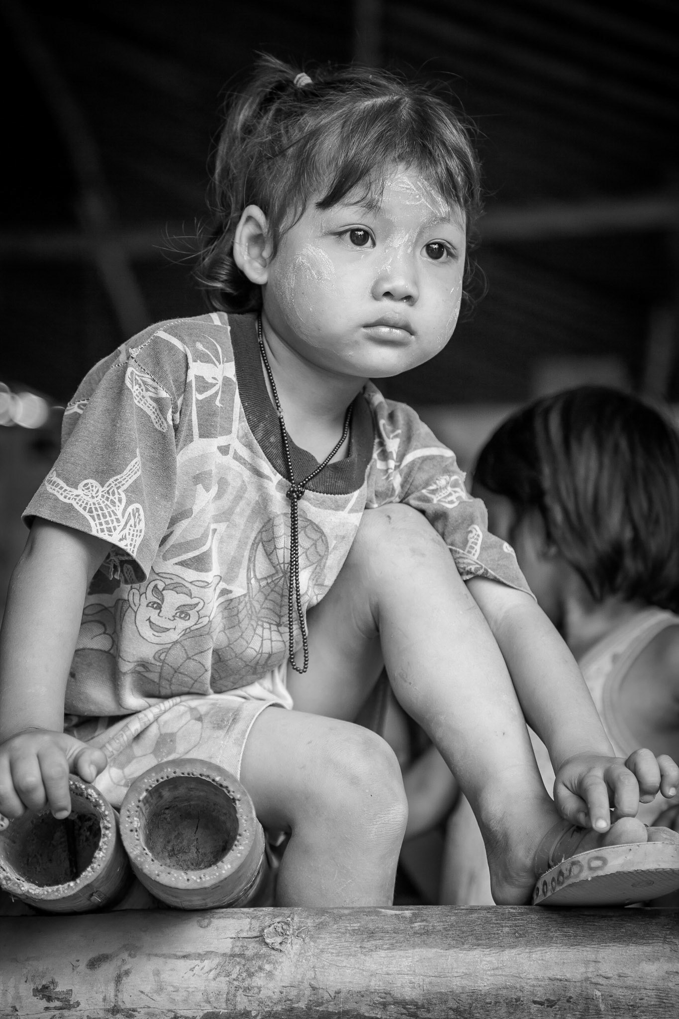 Young, Burmese Karen, girl with traditional sun screen applied to her face.