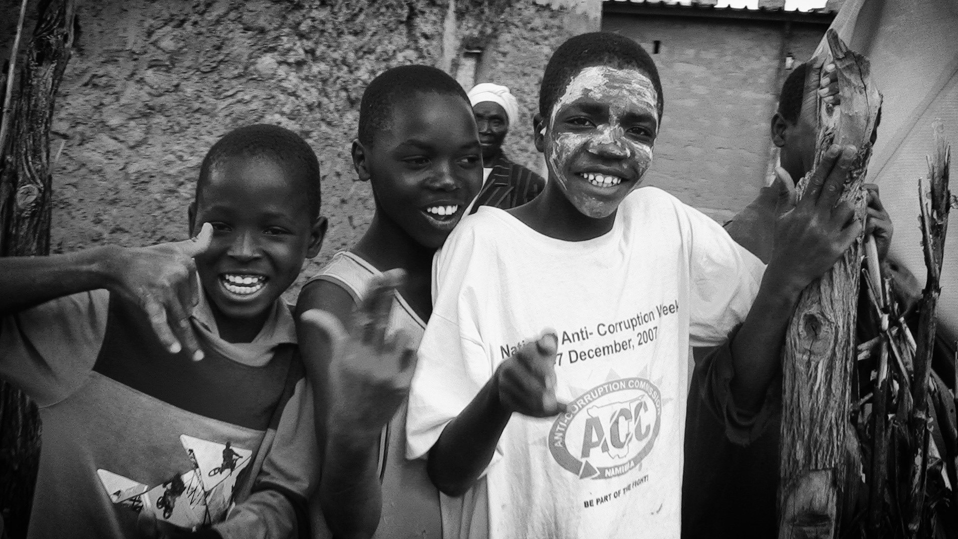 A group of smiling Angolan refugee boys in a Namibian refugee camp.