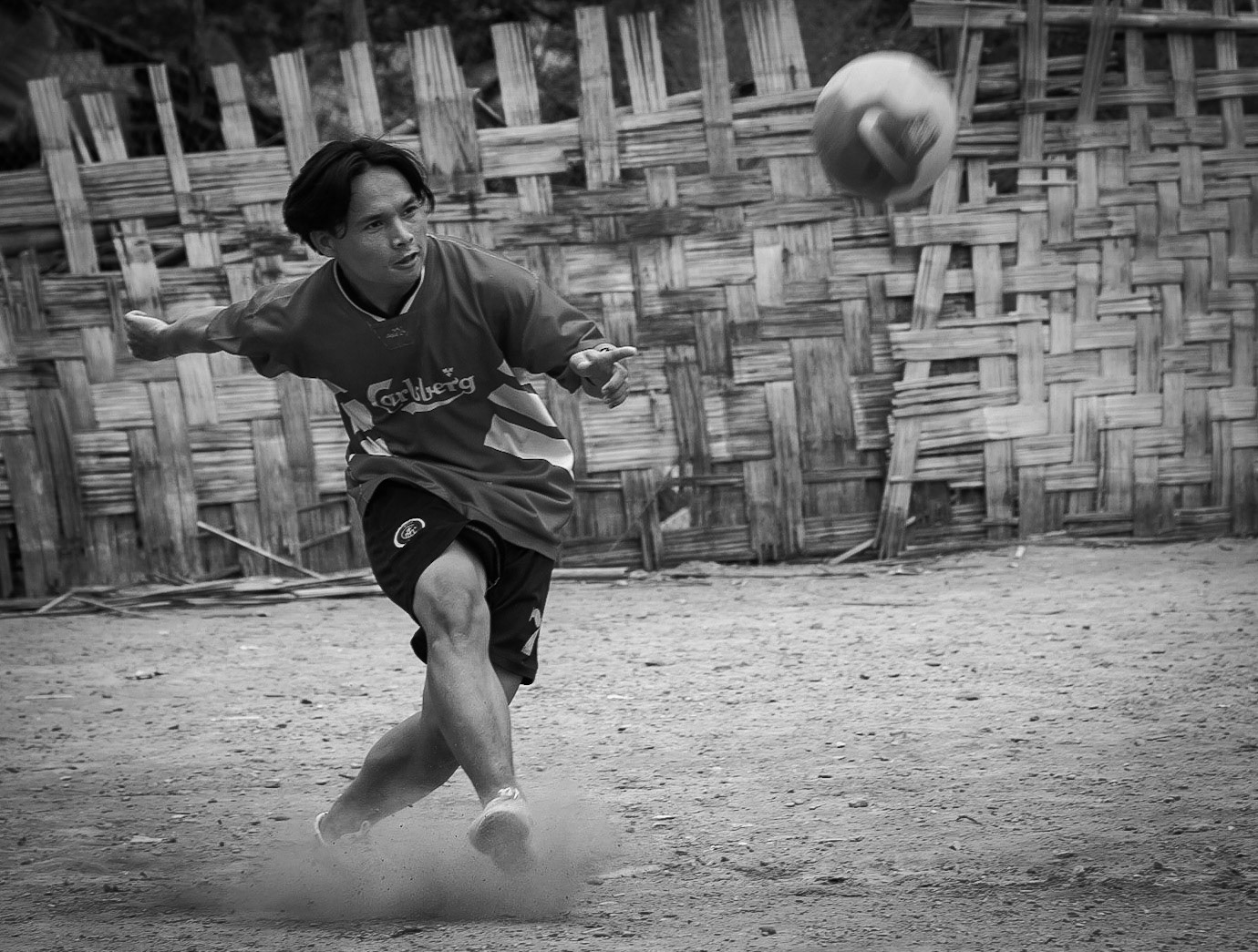 Burmese Karen refugee playing football at Tham Hin refugee camp on the Thai, Burma border.