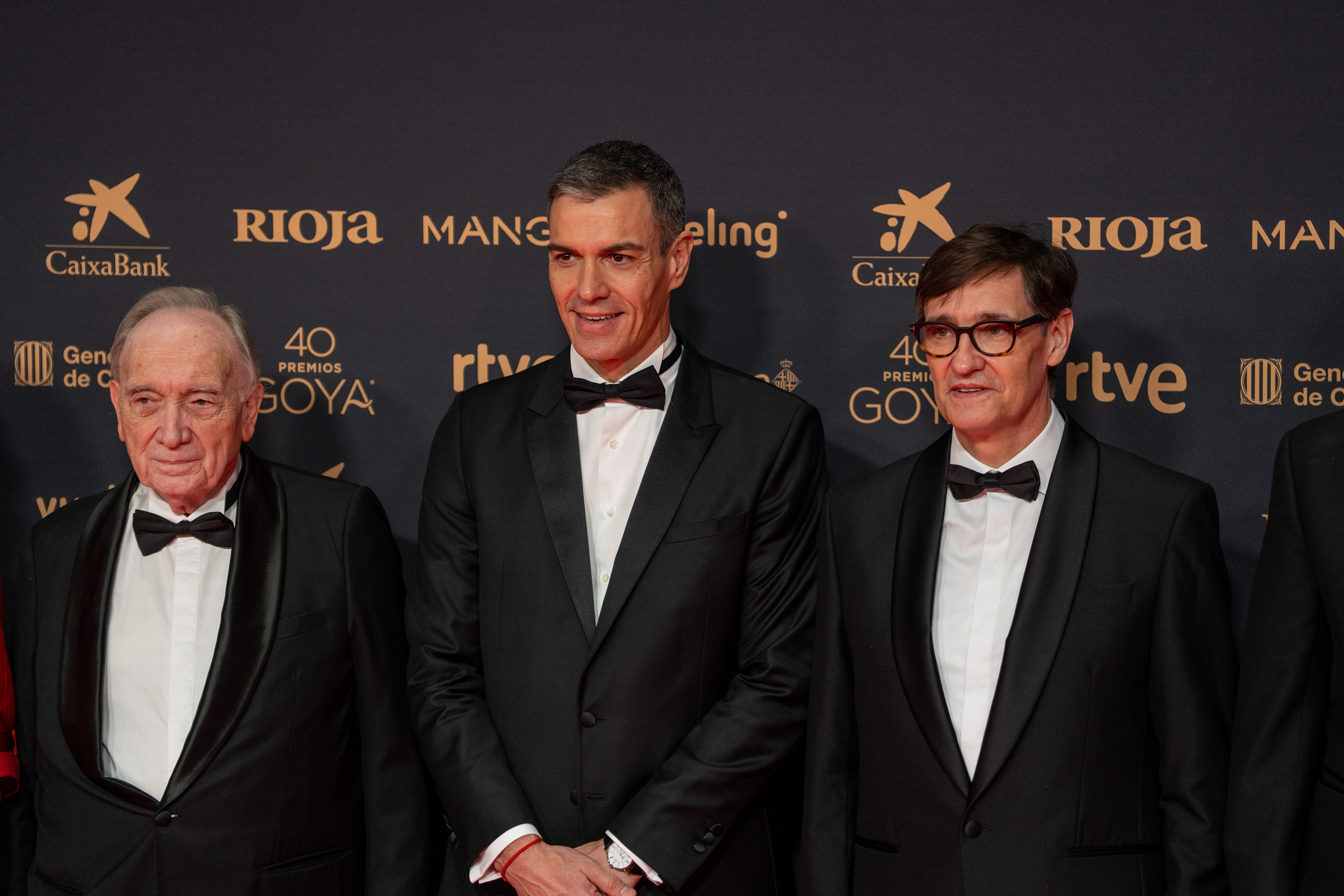 Spanish Prime Minister Pedro Sanchez, President of the Generalitat de Catalunya Salvador Illa, and the President of the Spanish Film Academy Fernando Mendez-Leite posing together on the red carpet during the Goya Cinema Awards ceremony