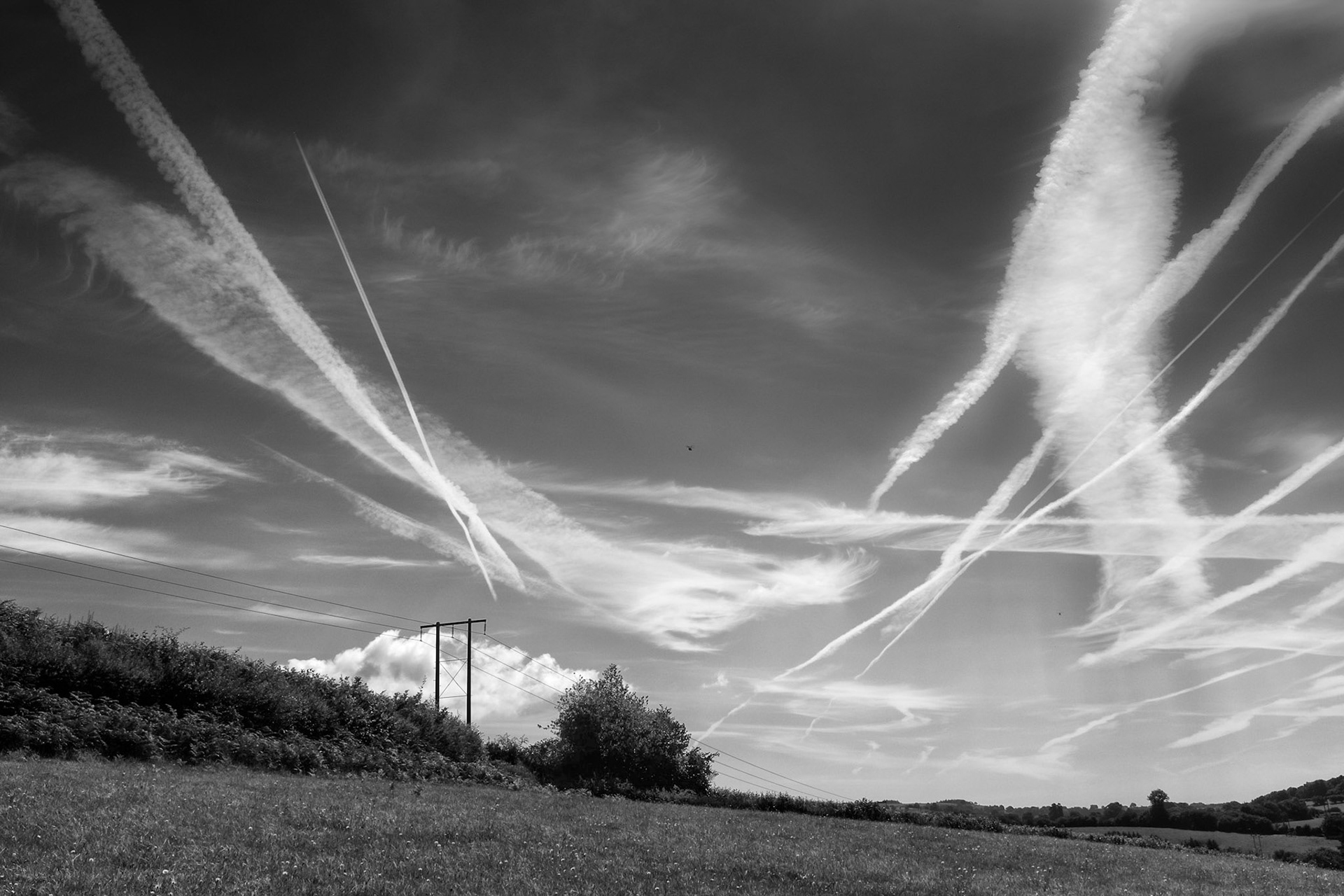 Landscape with power lines, contrails and helicopters, Brecon Beacons