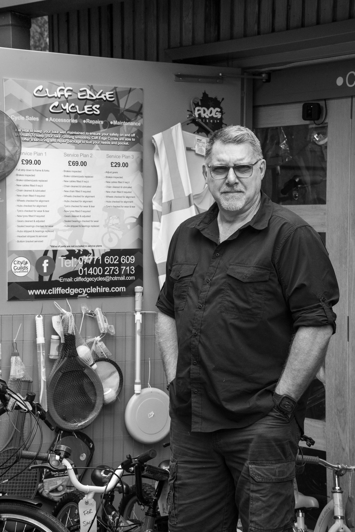 Wayne Stranger 6/100 This photo number 6 in my 100 Strangers project. Wayne owns Cliff Edge Cycles in Wyndham park and kindly agreed to being photographed. I feel that the composition says much about Wayne rather than a straight portrait. This picture is #06 in my 100 strangers project. Find out more about the project and see pictures taken by other photographers at the 100 Strangers Flickr Group page   