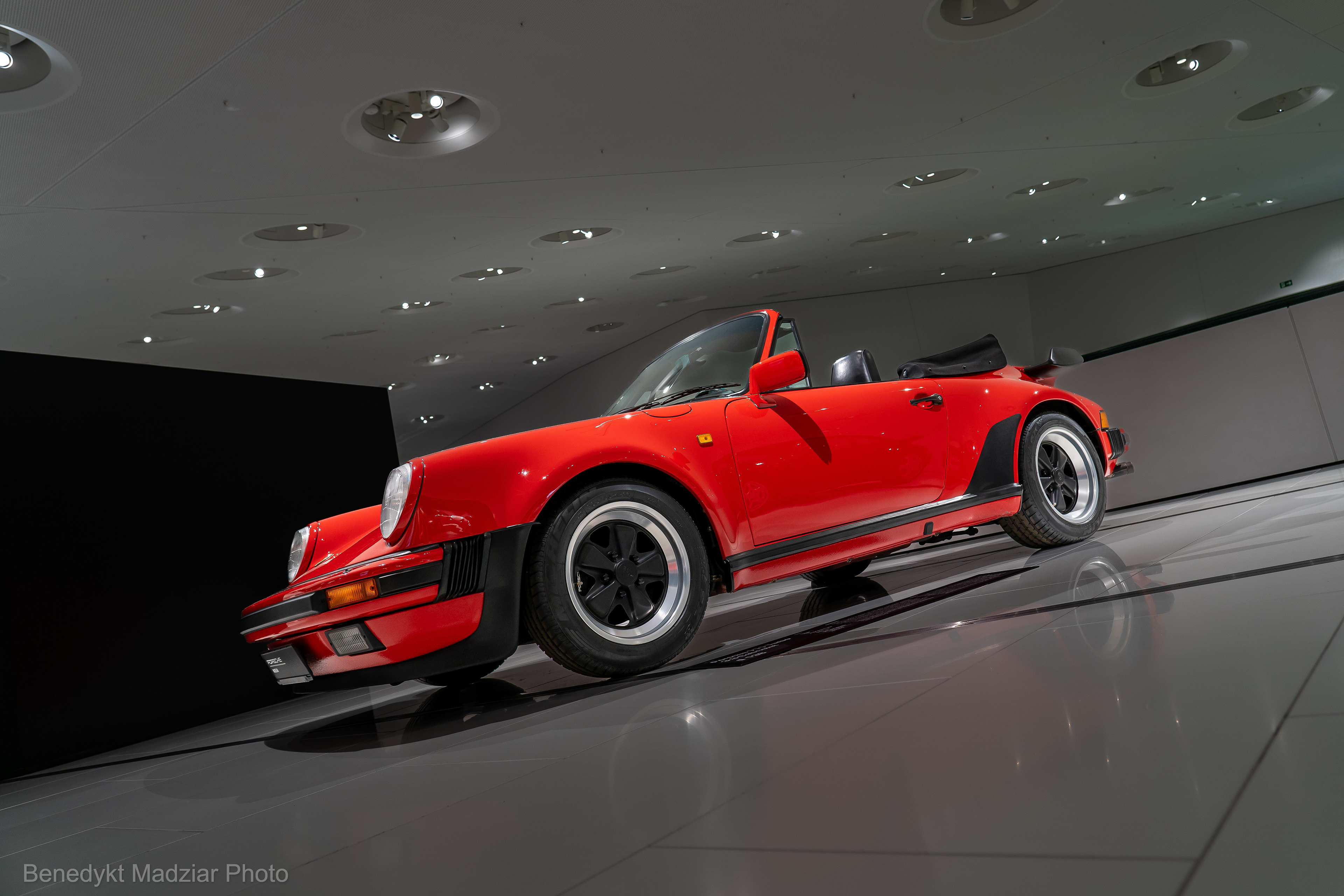 Porsche 911 Turbo 3.3 Convertible. The Turbo 3.3 (930) model introduced to the market was the most refined supercar model at that time, also suitable for everyday use. It boldly kept pace with both Lamborghini and Ferrari. The Turbo 3.3 was a modernized version of the first Turbo model from 1975, still as the G Series from 1973. The engine was still a 6-cylinder boxer, but with a capacity of 3.3 liters, and the power increased to 300 HP. The car was equipped like the first Turbo model with a 4-speed manual gearbox. The Turbo 3.3 was created in three versions: Coupe, Targa and Convertible. A total of over 18,000 Turbo 3.3 units were sold around the world between 1978 and 1989, where Porsche initially expected sales about of 400 units. The model in the photo comes from the last year of production (J Series), 1989, which already has a 5-speed manual gearbox.