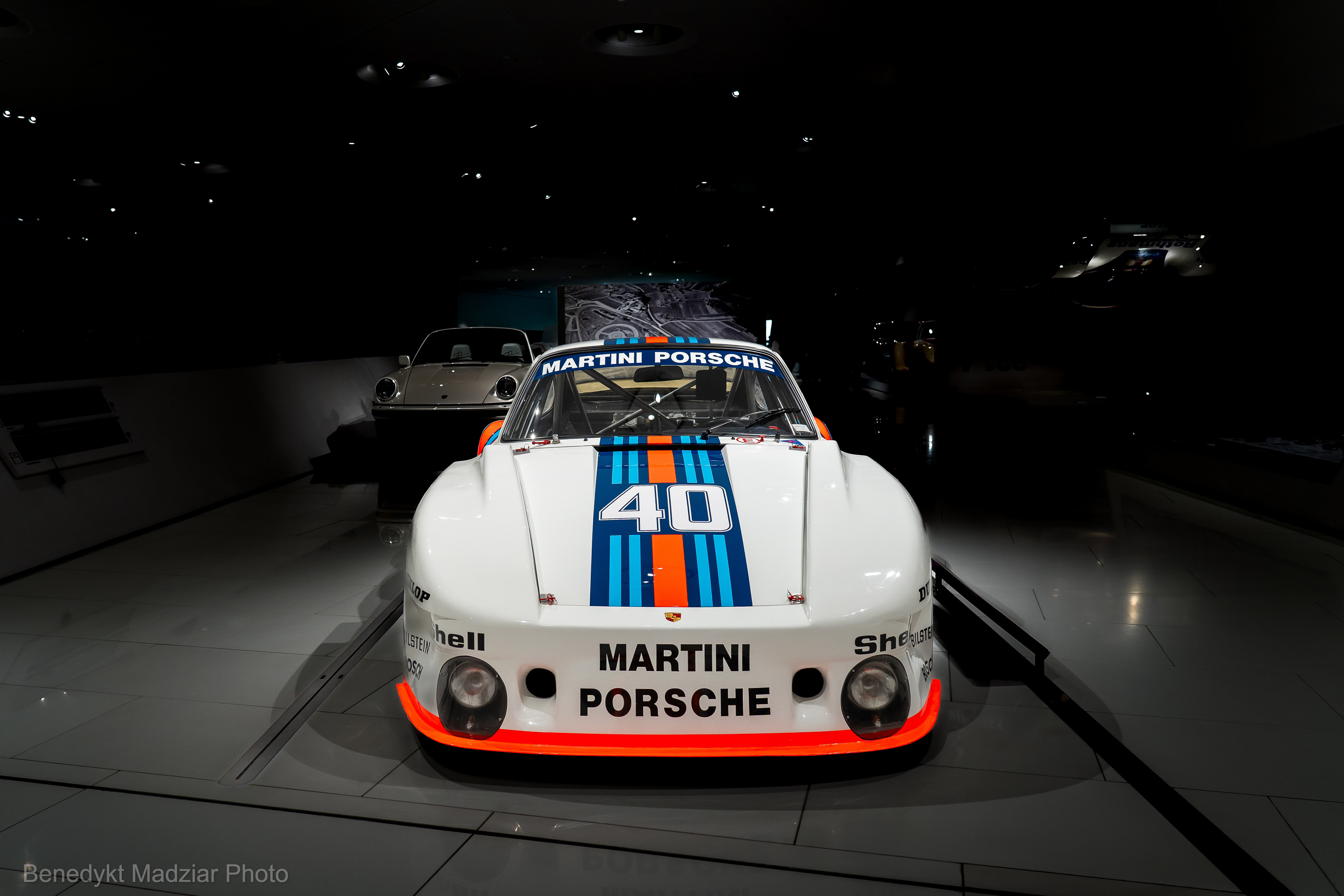 Porsche 935 "Baby". The „Baby” version, called it due to reduction in engine displacement - 1.425 litre. The 935 was built to prove that Porsche could enter the sub-2-litre racing class in the DRM Championship (Deutsche Rennsport Meisterschaft), which was dominated by BMW and Ford. Apart from its 911-like bodywork, the 935 was the first step towards to create a new image for Porsche racing cars. The model had a unique body kit with two „clever”, aerodynamically efficient solutions: - the first one was a rear spoiler with integrated air intakes in the C-pillar - the second one is the rear-view mirrors integrated with the front fenders The car, although it had an engine with a capacity of only 1.4 liter, of course a 6-cylinder boxer with turbocharging, generated power of up to 380 HP, accelerated to 270 km/h, and its weight was only 710 kg! Although the premiere of the Porsche 935 at the Norisring in Germany turned out to be a failure, during the second start at the Hockenheimring In 1977 the 935 „Baby” - as Dieter Landenberger wrote - crushed its rivals and a racing driver Jacky Ickx was at the finish line with an advantage of over a minute (and that’s a lot). Thus, Porsche proved to BMW that they can beat them even in DRM races in the sub-2 liter class. From there, „Baby” went straight to the Porsche Museum and the photos show exactly the 1977 model described above.