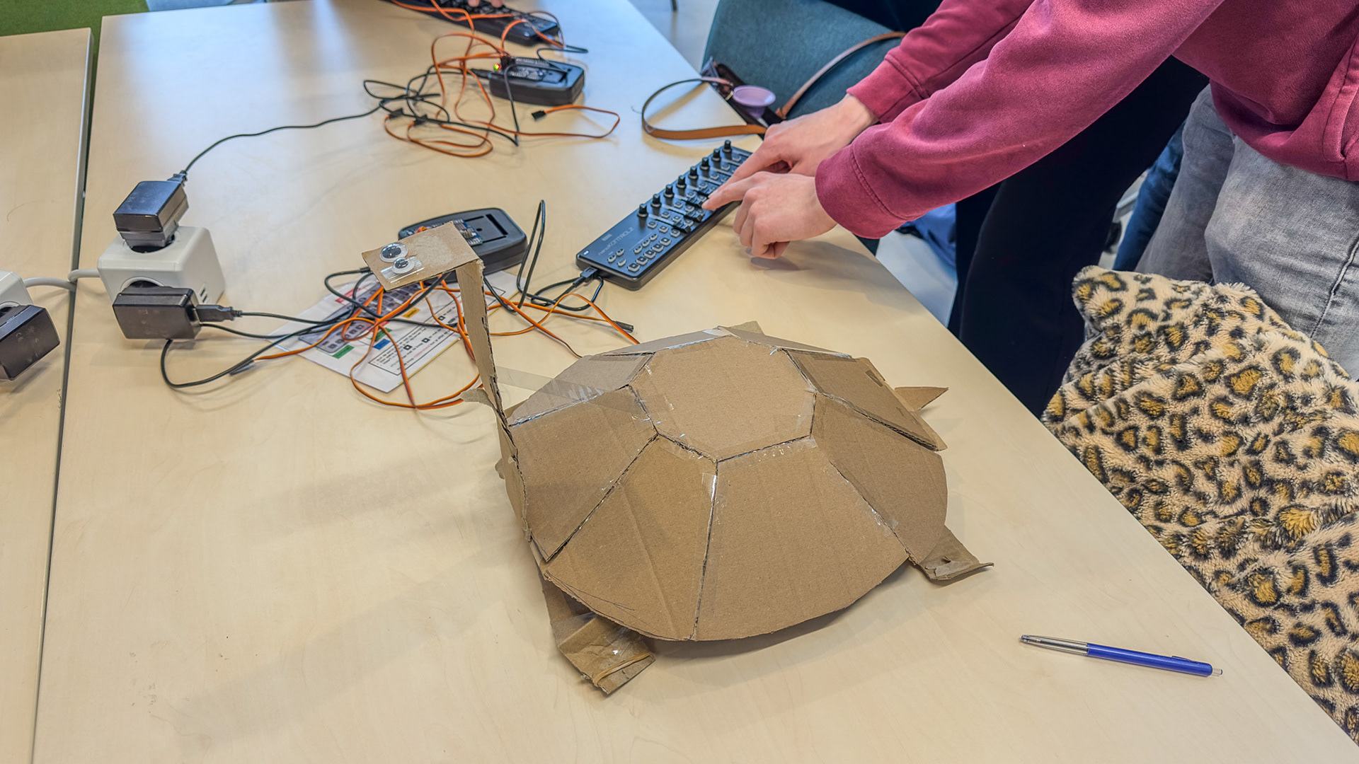 Figure 8. The third iteration of the turtle (rubber bands) and programming the servos.