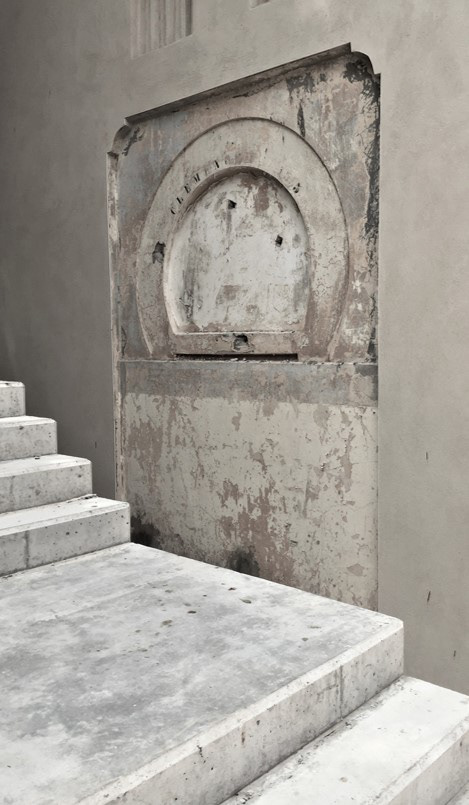 Revealing the arch next to concrete addition