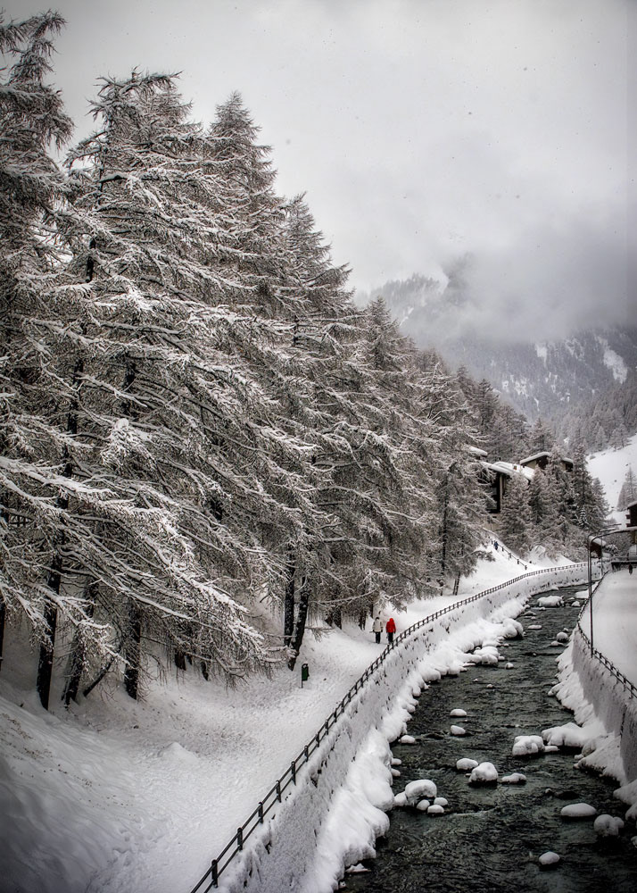 #4014 Couple Walking on Path, next to a Stream, under Snow Covered Trees in Zermatt, Switzerland