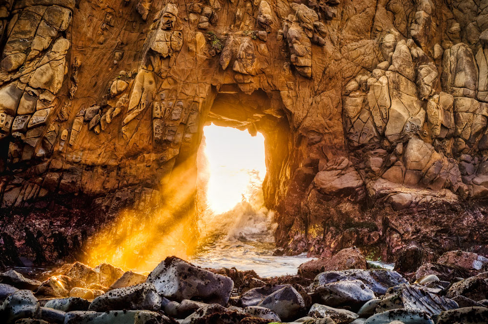 #1025 Late Afternoon Sunlight Shining Through a Hole in the Rock Wall at Pfeiffer Beach on the Big Sur Coast