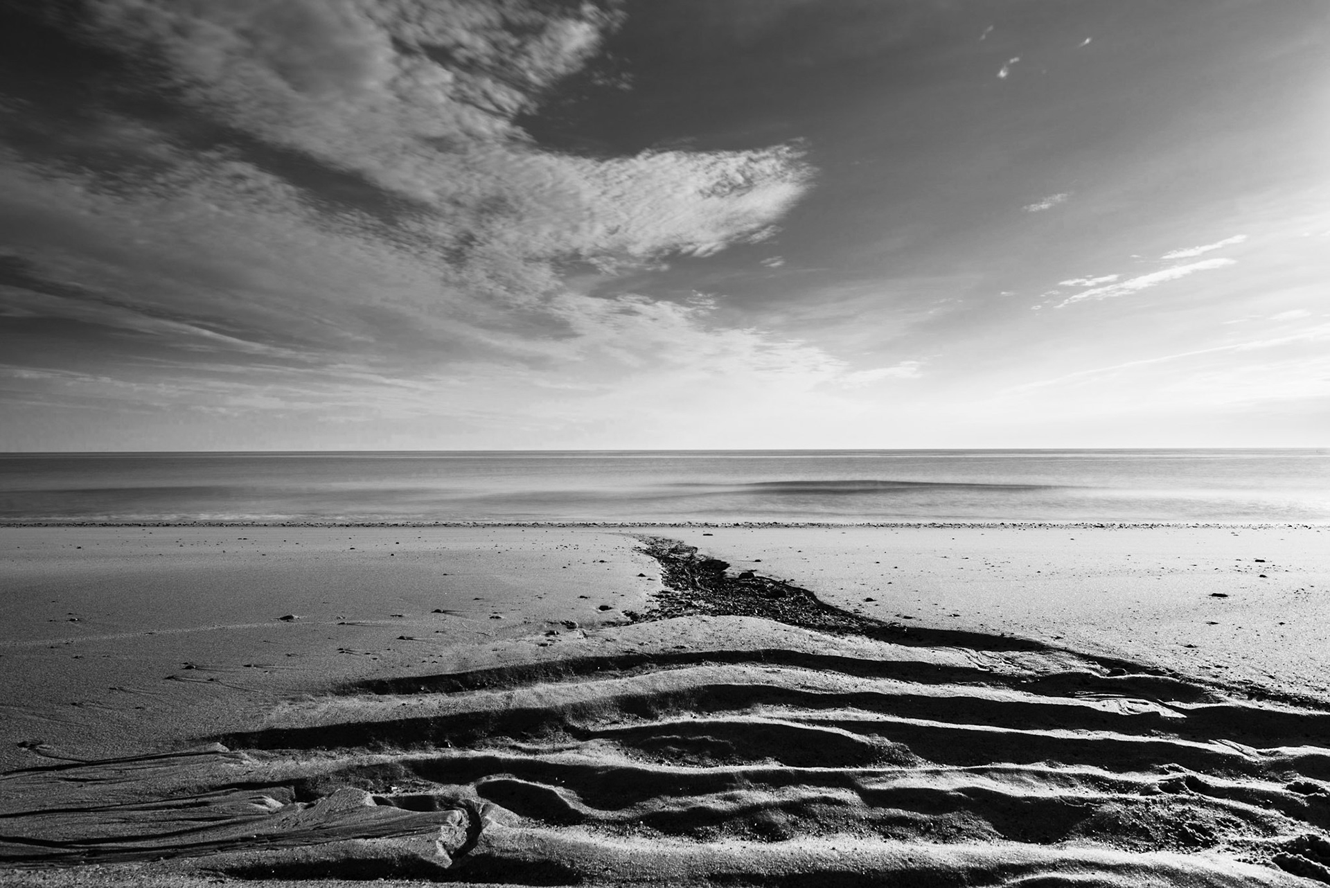 Sand erosion at low tide on the beach. (photo by Gabe Palacio)