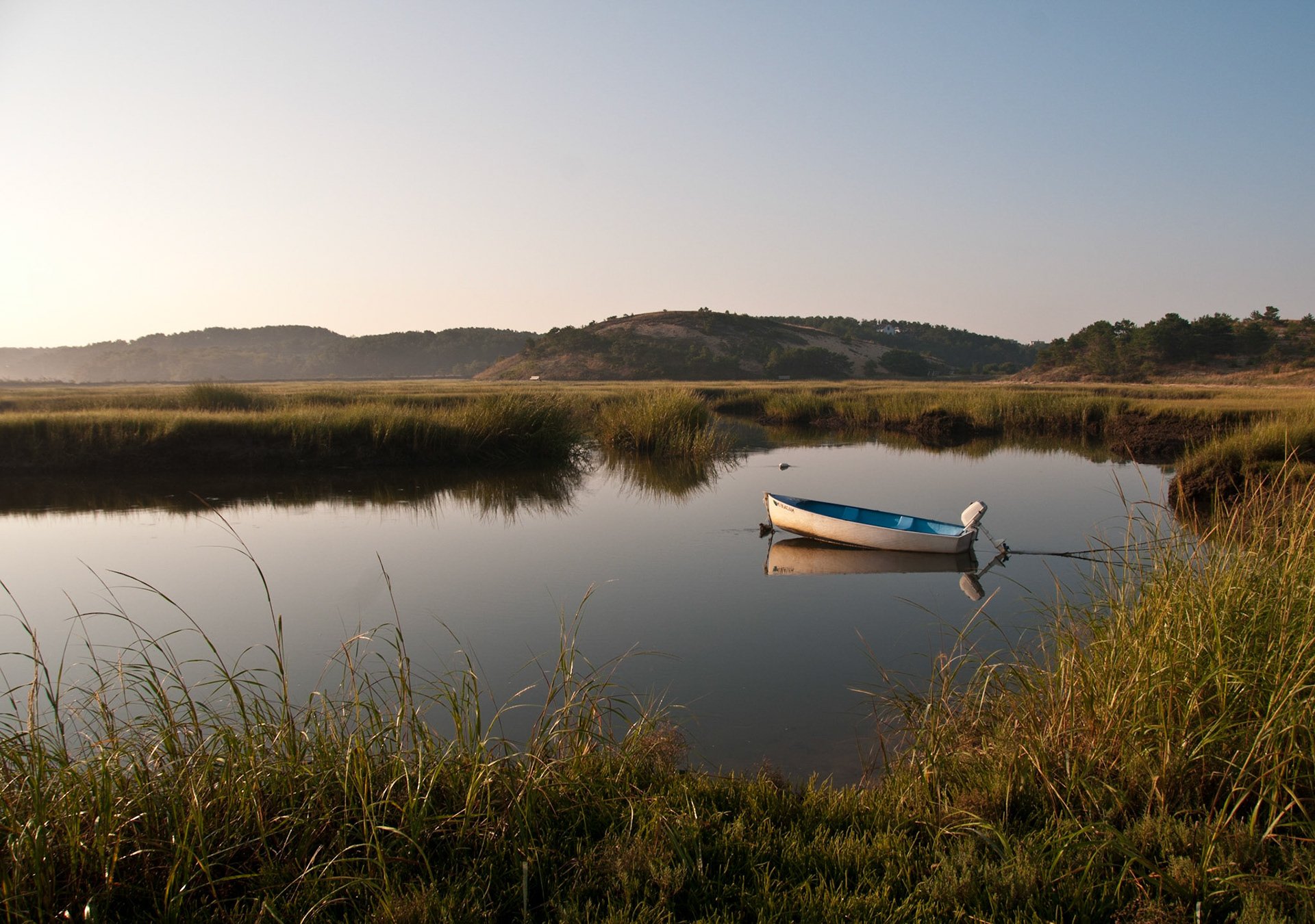 A small boat sits ideal in a marsh on Cape Cod in Truro, Massachusetts.   (photo by Gabe Palacio)