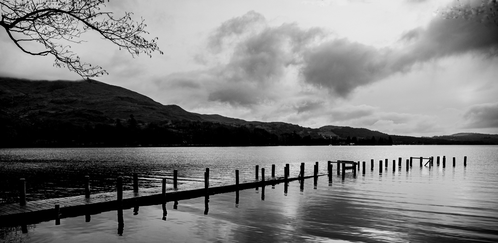 Winter on Coniston-Old pier moves into the light by Phil Day