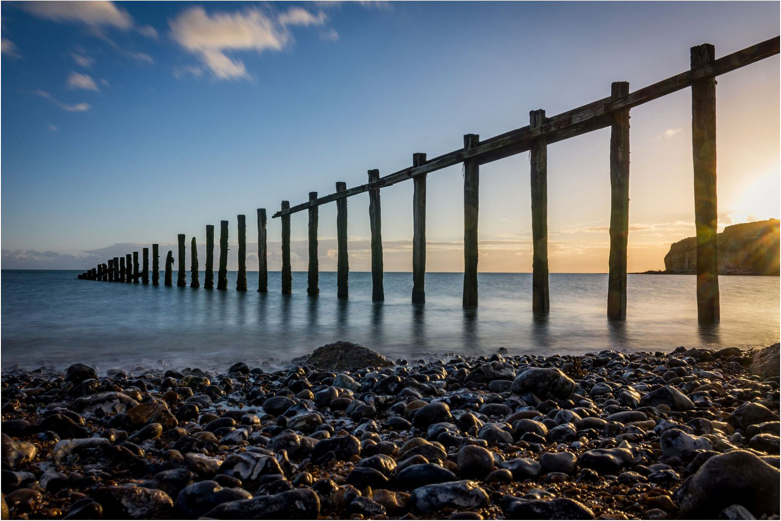 Calm waters at sundown by Bogdan Schiteanu