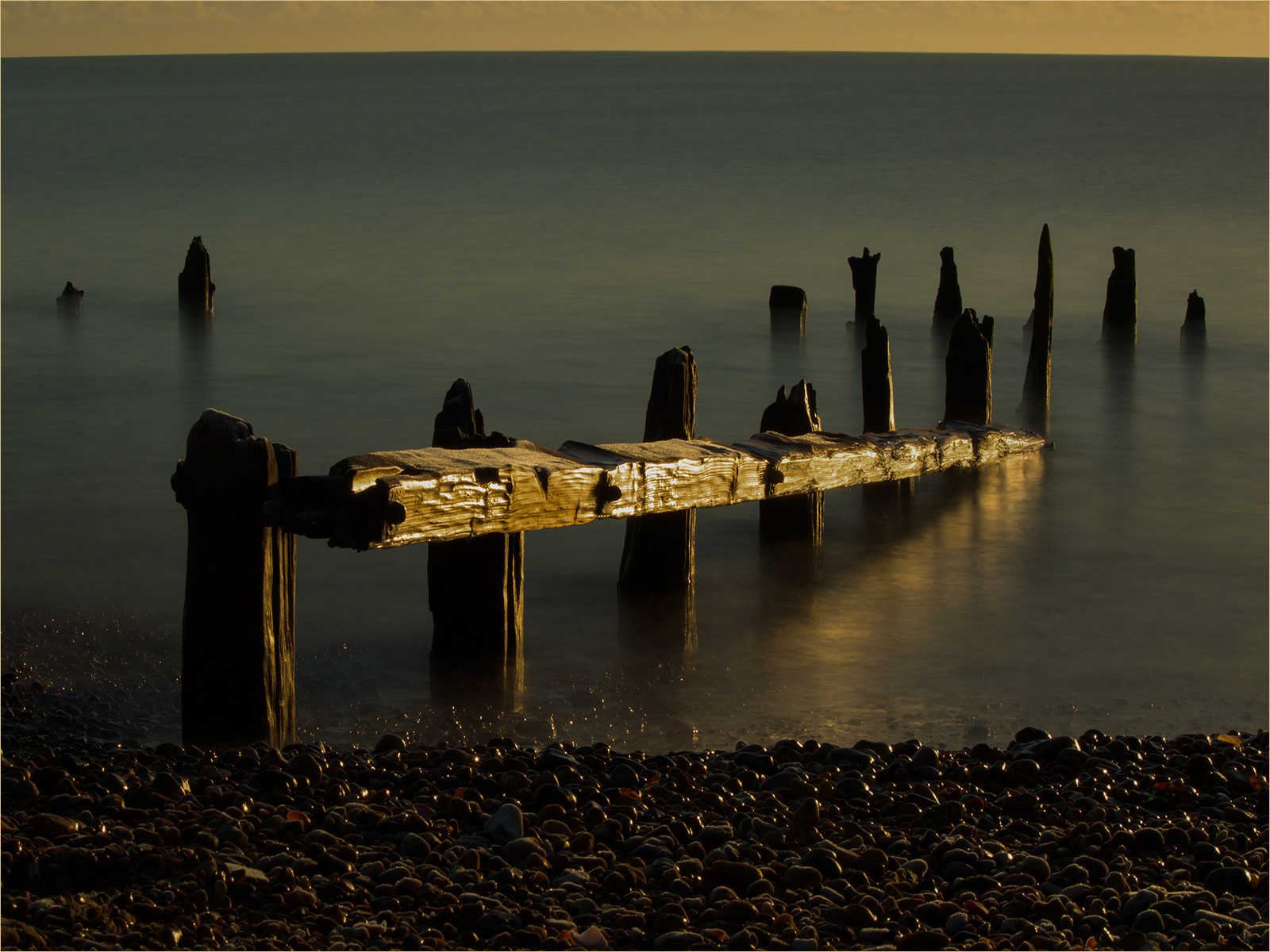 Wooden beam into water by Catherine Allum
