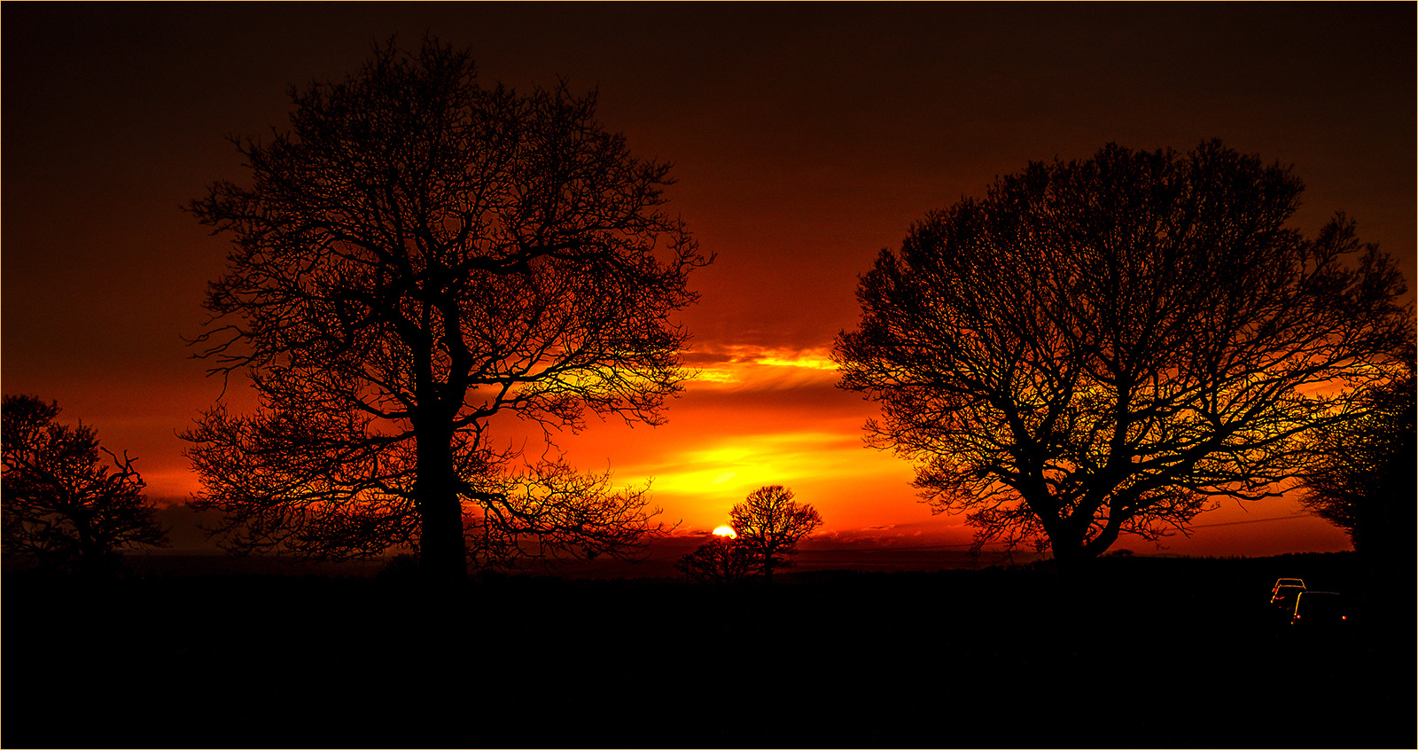 HELD BACK Sky on fire at sunset by Bogdan Schiteanu