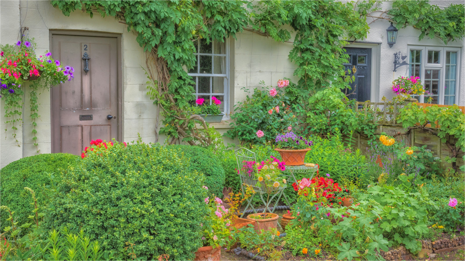 HELD BACK  Garden at Roses Cottages Dorking  by  Richard Knapp