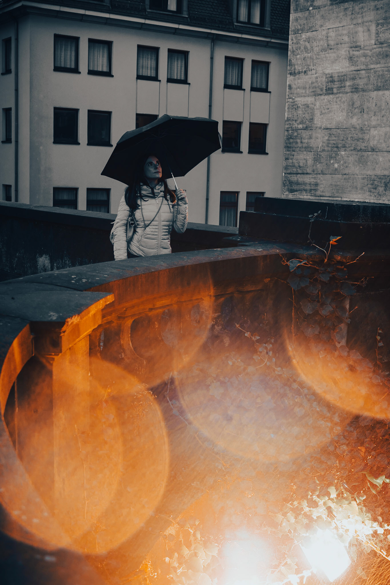 Rain mixed with a bright light source, some longer exposure and drops on the lens... And of course the model :)