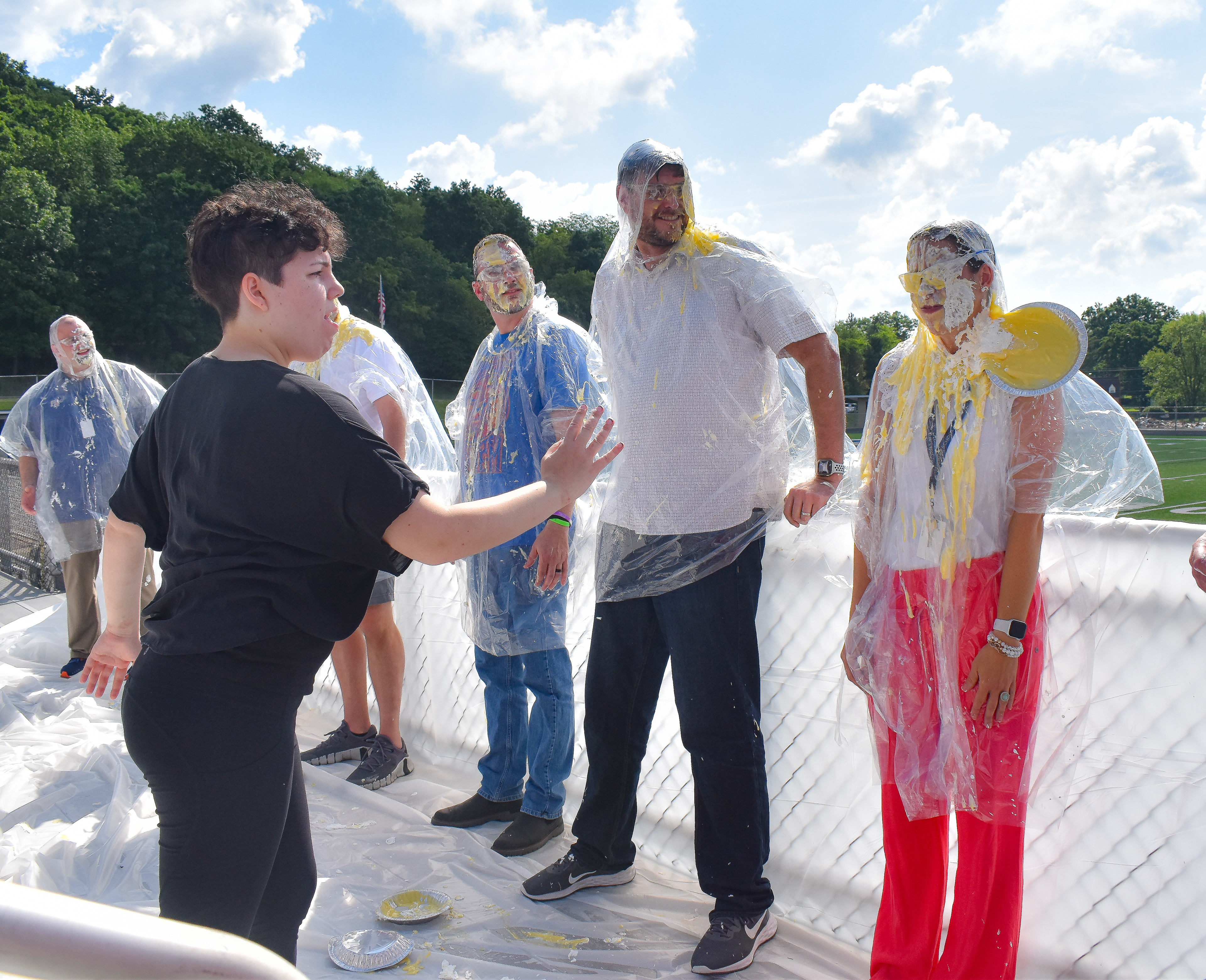High school students participate in a Pie-the-Teacher event.