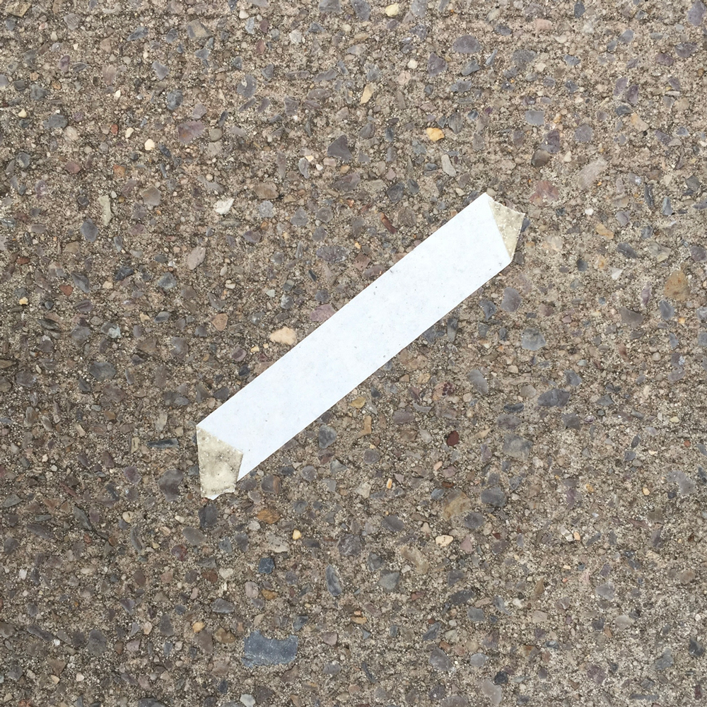 A photo of lost or discarded material found on a city street—with a form interpreted as resembling a Toblerone candy bar.