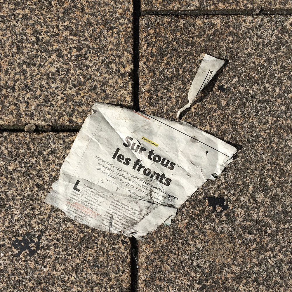 A photo of lost or discarded material found on a city street—with a form interpreted as resembling a dust pan.